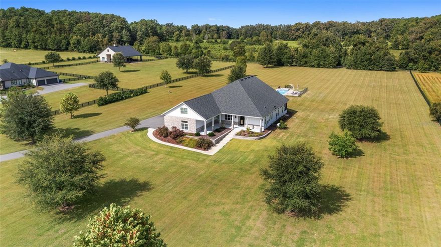 Custom Home Built in 2022 located in Red Oaks Estates, A Gated Community off County Road 241.  5 Acres!  Cross Fencing, ideal for horses!  Electric Gated Entrance to the Home!  5 Bedrooms, 3 Baths, 4-Way Split Plan! High Ceilings!  Two Master Bedrooms with En Suites!
Primary Master has screened porch to enjoy the views in the evening!  Spacious Bathroom has separate vanities, oversized walk-in shower with bench, garden tub and separate toilet room!  Large Walk-in Closet, Tray Ceiling!  2nd Master Bedroom is very unique with many of the same features as the primary master bedroom!  Spacious Gourmet Kitchen features an island, soft close cabinets, breakfast bar, desk area, upgraded appliances, Pantry and porcelain countertops!  Open Floor Plan!  Lots of natural light, high end finishings!  Built-in Gas Fireplace! Crown Molding throughout!  5th Bedroom upstairs or use as an office.  The Spacious Laundry Room has cabinets galore, utility sink plus a storage closet.  This home features a 24 KW Generator, Two Tankless Hot Water Heaters, 150 ft Well, and a 500 Gallon Propane Gas Tank.  Designer Side Walks to the front Entrance.  Wrap Around Front Porch to relax and enjoy the views.  Very Unique 15 x 30 Salt Water Pool, Spacious Patio, Attractive Pavers.  Jacuzzi!  Safety Fence!  Close to Shopping, University of Florida, Millhopper Road, 25 minutes to UF Shands Hospital and only 8 miles from I-75.  Countryside Charm!  Florida Living at It's Best!

A perfect blend of luxury, privacy and peacefulness!  Sunset Views hard to believe!