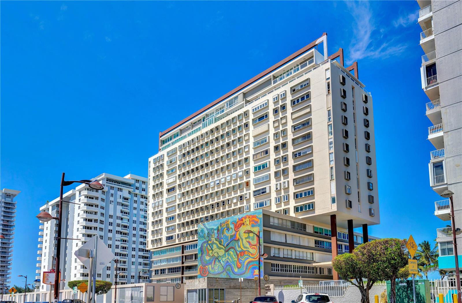 Located on the 12th floor of the esteemed Surfside Mansions condominium, this oceanfront apartment offers direct beach access and panoramic views of the Atlantic in the heart of Isla Verde, one of Puerto Rico’s most vibrant beachfront neighborhoods. The residence features a comfortable layout with three bedrooms and three full bathrooms. The primary suite includes ocean views, a walk-in closet, and a private en-suite bath. Two additional oceanview bedrooms provide flexible living spaces, complemented by well-distributed bathrooms and generous natural light throughout. Surfside Mansions offers a range of amenities designed for convenience and enjoyment, including 24/7 security, direct beach access, a beachfront swimming pool, two fitness centers, playground and activity rooms. The building is equipped with fiber optic internet, a water cistern, and has approved installation for a full power generator. It also includes infrastructure for electric vehicle charging. The property is ideally located within close proximity to supermarkets, restaurants, and nightlife, with quick access to major highways for ease of travel across the San Juan metro area. With open ocean views, beautiful sunrises and moonrises, and a prime location, this apartment offers a relaxed coastal lifestyle with everyday convenience.