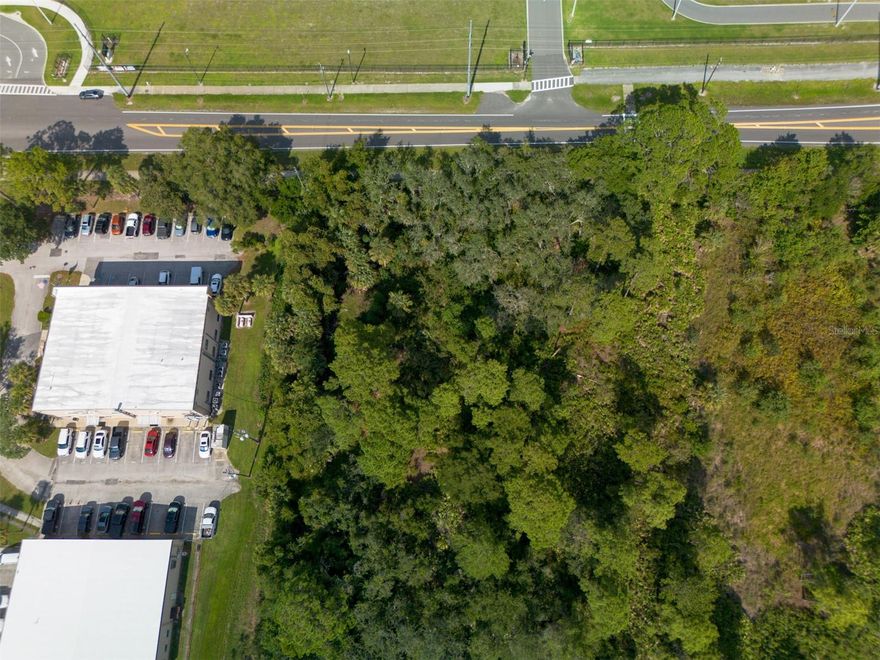 Prime 0.83-acre commercial/industrial lot in Deltona with 175’ of frontage on Enterprise Road, directly across from Deltona Middle School. High visibility with public-maintained road access and sidewalks. Utilities, including cable, electricity, and water, are available nearby. Located in Flood Zone X, with a survey on file, low annual taxes, and versatile for business development or investment in a growing corridor.