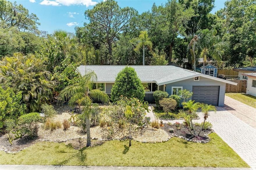 This meticulously-maintained, upgraded, move-in-ready Mid-Century Modern gem exemplifies pride of ownership and attention to detail. Featuring a 2022 ROOF with ALL 9 HURRICANE WINDOWS & HURRICANE FRONT & BACK DOORS installed in 2022, there is also a permitted, anchored 2018 shed with lighting, electricity,, mobile A/C unit, & exterior kayak racks.  The house is pre-wired for solar panels & the partially pavered backyard is wired with a 240V 40V circuit with required breaker with GFI protection to plug into a hot tub!  Also in the bamboo-ringed backyard is an outdoor shower with new tankless propane water heater, raised metal garden bed, & fire pit.  The open kitchen features granite countertops, an island, garbage disposal, & under counter water filter cartridge with sink spigot & feed to ice maker in refrigerator.  Also featuring vintage TERRAZZO floors in excellent condition, a separate dining room, queen-sized Murphey bed in the front bedroom, 2-stage A/C, upgraded CPVC incoming plumbing, spray foam insulation throughout the the attic space, perimeter termite protection with transferrable, recurring service, single-car garage with remote electric garage door opener, & a second pavered driveway that runs along the side of the house for additional parking &/or RV & boat storage.  Located in the charming, mature, close-to-downtown, west-of-Tuttle-Ave Alta Vista neighborhood, the property sits at one of the highest elevations above sea level in town & is in Flood Zone X.  Enjoy the freedoms of no deed-restrictions or HOA!  Alta Vista is experiencing an urban revitalization with new, million-dollar-plus houses infilling throughout the neighborhood, increasing property values.  Walk to the new 18.5-mile-long biking & pedestrian Legacy Trail, that goes all the way south to Venice and terminates on the other end less than a mile from the property at beautiful Payne Park, where there are multiple duck ponds, enjoyed by a variety of waterfowl & turtles, a full frisbee golf course, a cafe, a circus-themed playground, tennis courts, skate park, shaded walking trails, public restrooms, & expansive green space for picnics & dog frolicking.  Half a mile towards Venice on the Legacy Trail is Pompano Park, featuring new pickleball courts, playgrounds, covered picnic benches with grills, tennis courts, a basketball court, free bicycle maintenance station, and public restrooms.  Modern Bay St Publix grocery store is less than a mile away, Sarasota Memorial Hospital is within 2 miles, & charming downtown Sarasota, with famous Selby Gardens, Selby Public Library, Opera House, Symphony, new Bayfront Project, & a variety of restaurants, shopes, & theaters is less than 2 miles away.  The crystal "sugar" sands of the #1-rated Siesta Key Beach are only 8 miles away & St Armands Circle, with upscale shopping & dining, & Lido Key Beach are only 5 miles away!