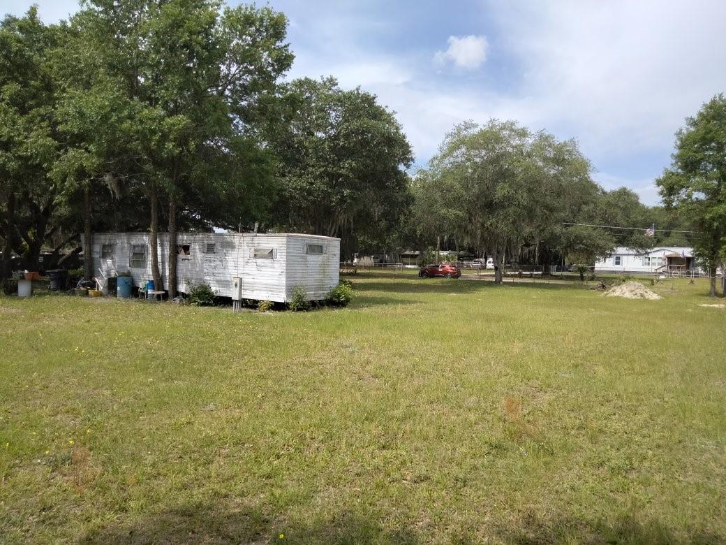 Get ready to jump on a golden opportunity to own a charming 0.66-acre slice of Mulberry paradise! This property already features a cozy 288 sqft tiny house, perfect for your weekend getaway, Airbnb potential, or a simple peaceful retreat. But that’s just the start—this is your chance to truly make it your own. Whether you want to upgrade the existing mobile home to a sleek new model or build the home of your dreams, the possibilities are endless! You’ll have tons of room to spread out: imagine a spacious workshop for all your DIY dreams, a she- shed for crafting your next masterpiece, or the perfect spot for an herb garden that’ll make your neighbors jealous! With no HOA and no pesky restrictions, you can live life on your own terms, raise chickens, plant a garden, or just kick back and enjoy the serenity of country living, all while being just minutes from city amenities like supermarkets, restaurants, and entertainment. Whether you’re investing in the future or building your forever home, this is the place where your vision can come to life.