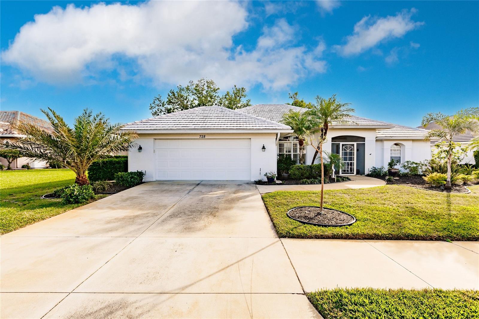 Step into the Florida lifestyle with this beautifully updated 3-bedroom, 2-bath home in the sought-after Lakes of Jacaranda community. Featuring a new 2023 concrete tile roof, brand-new 2025 water heater, new electrical panel 2025, and lush tropical landscaping, this home makes a lasting first impression with its inviting screened front porch and curb appeal. Inside, you'll be welcomed by a bright, open floor plan with soaring ceilings and abundant natural light pouring in through quadruple sliding glass doors. The spacious living room flows seamlessly into a generous dining area and a stylish eat-in kitchen, perfect for both entertaining and everyday living. The kitchen is a chef’s delight, featuring newer stainless-steel appliances, quartz countertops, a breakfast bar, and a cozy dinette area with direct access to the screened rear porch—ideal for enjoying morning coffee or evening breezes. Retreat to the private primary suite, complete with sliding doors to the porch, a large walk-in closet, and a spa-like ensuite bath with dual sinks, a makeup vanity, and a beautifully tiled walk-in shower. Two additional bedrooms (one currently used as a den) and a full guest bath provide comfort and flexibility. Additional features include a newer 2019 HVAC system, tile flooring throughout, irrigation well for the lush backyard oasis, washer/dryer, and extra freezer included. Enjoy the exceptional amenities of Lakes of Jacaranda: a resort-style clubhouse, swimming pool, tennis and pickleball courts, all just minutes from the Gulf of Mexico and stunning local beaches. This move-in-ready home combines modern updates with laid-back luxury—Florida living at its finest, MOTIVATED SELLER – VA LOAN ASSUMABLE.