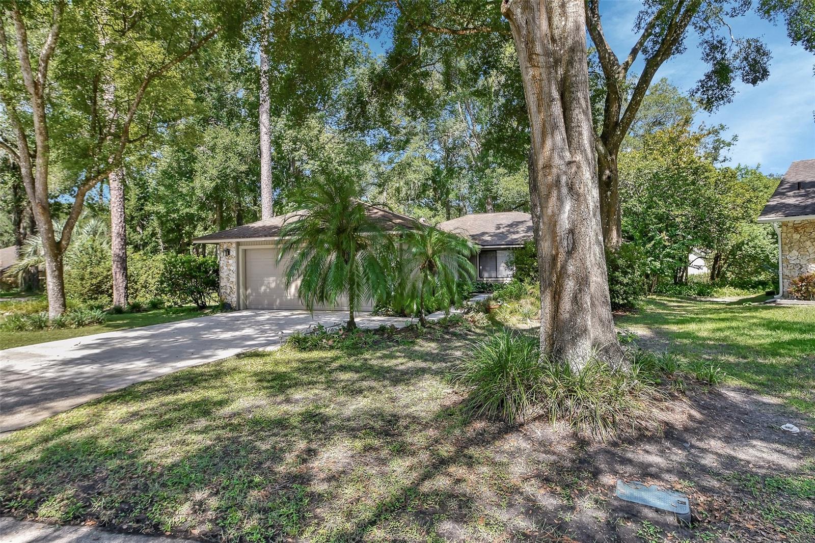 Welcome to this meticulously maintained custom three-bedroom, two-bath home with a spacious two-car garage, nestled at the end of a peaceful cul-de-sac on a prime corner lot in the desirable Trails West neighborhood of DeLand. Surrounded by vibrant native Florida landscaping, this home offers both beauty and privacy.
Step inside and be greeted by rich 3/4” solid teak wood flooring that flows elegantly throughout most of the home. The thoughtfully designed eat-in kitchen is a chef’s dream, boasting newer custom solid wood cabinetry and luxurious Silestone natural quartz countertops—just one of the many quality upgrades found throughout the home.
Enjoy outdoor living on not one, but two inviting porches. The front porch offers a welcoming view of the lush surroundings, while the screened side porch provides a tranquil space for relaxing afternoons—both featuring gorgeous tongue and groove ceilings that add warmth and charm.
Additional features include a spacious two-car garage and access to exceptional community amenities just steps away, including a clubhouse, pool, and tennis courts.
Ideally located just minutes from award-winning Downtown DeLand, you’ll be close to boutique shops, top-rated restaurants, and vibrant cultural events. This is a rare opportunity to own a truly special home in one of DeLand’s most beloved communities!