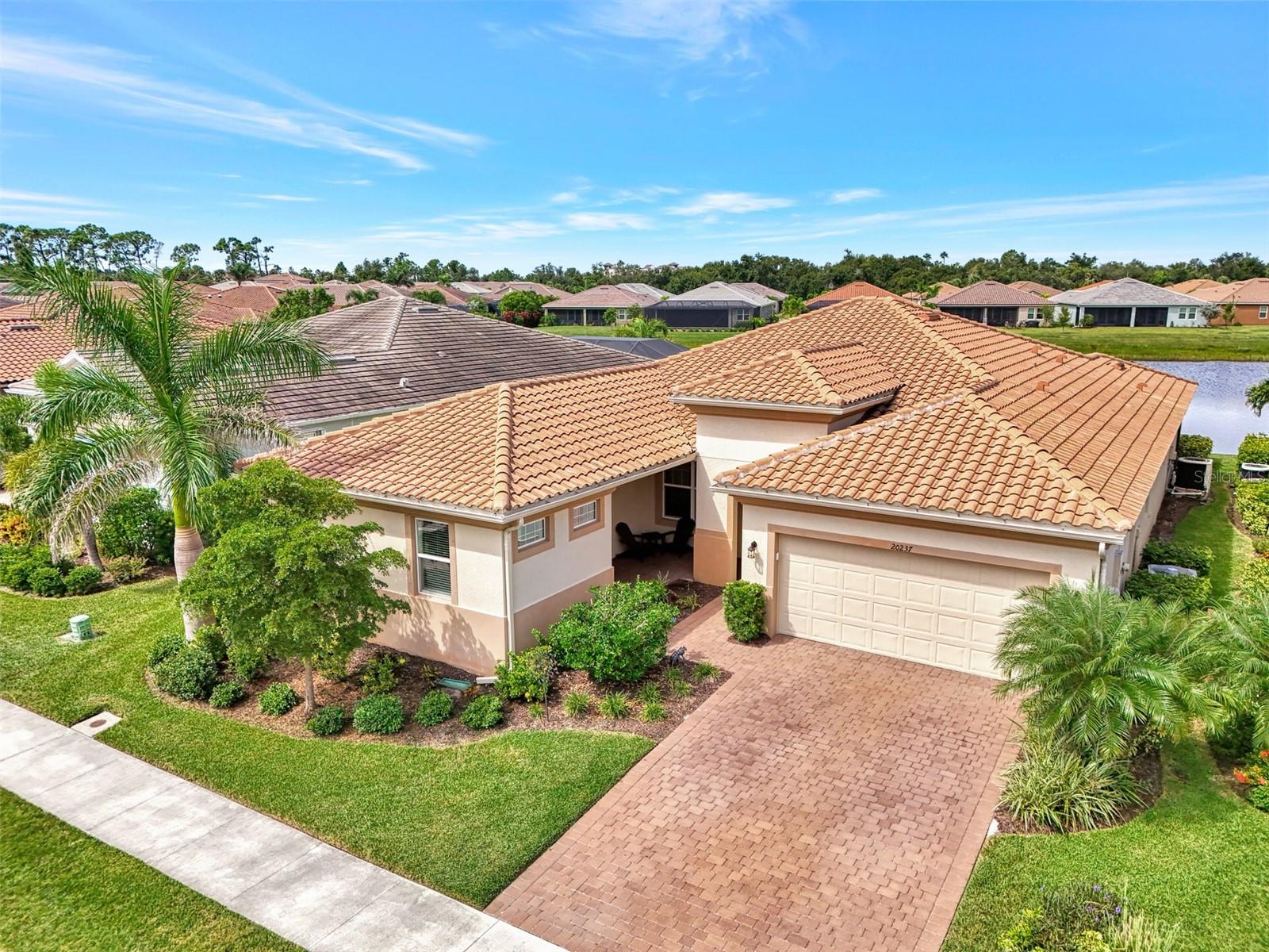 Now is your opportunity to own this 2021 built home located in the amenity rich gated community of Renaissance at Wellen Park. This 4-bedroom, 4 full bathroom, plus bonus room, home was expertly designed with almost 2900sf of open concept living space, making this one of the lowest price per sf one-story pool homes in all of Wellen Park. Situated on a beautiful pond with stunning Florida sunsets, the sparkling heated saltwater pool was upgraded with decorative tile that mimics the waves of the ocean, a tranquil water feature, and a clear view screen. The lanai area is perfect for both entertaining and relaxing! Best of all, NO FLOOD INSURANCE REQUIRED! There is a welcoming front porch to enjoy. Step through the front door to be greeted by a spacious dining area that leads into an oversized living room. Throughout the main living spaces you will find upgraded 12x24 tile, multiple tray ceilings with crown moldings, extra recessed lighting, and designer light fixtures and fans. The kitchen showcases raised panel cabinetry, beautiful Cambria quartz countertops, built-in stainless-steel appliances, and a modern range hood that is vented to the outside. There is a massive island with a single-bowl sink that is perfect for entertaining, and a large walk-in pantry. The eat-in kitchen offers a spacious dinette area with custom wood wall details. Enjoy the water view from every angle as you move through the home. The primary suite is flooded with light thanks to three large windows and has luxury vinyl plank floors, a tray ceiling, and decorative woodwork and wallpaper on the accent wall. The en suite has an oversized dual sink vanity with loads of storage, a large walk-in shower, a separate water closet for privacy, and a massive walk-in closet. The three other bedrooms are in separate areas of the house, making each one private. Each bedroom enjoys luxury vinyl plank floors, making this house completely carpet free! Each bedroom feels like an en suite with access to its own full bathroom, and all of the showers were upgraded with tile to the ceiling. Just before you reach the 4th bedroom which has its own private entry to the front porch, you will find a light-filled bonus room with built-in dry bar. This space is perfect for creating a game/playroom, man-cave, home office, or flex space to suite your needs. The separate laundry room is easily closed off, and there are loads of closets throughout that help to create ample storage at every turn. The 2-car garage was upgraded with a showroom quality epoxy garage floor, and the HVAC system is equipped with UV Light, designed to enhance indoor air quality and reduce allergens. Some of the LOWEST HOA FEES in Wellen Park, Renaissance is a gated lifestyle community with resort style amenities that include a clubhouse with working kitchen and clubroom, pool with zero entry and lap lanes, hot tub, fitness center, outdoor patio with fireplace, tennis courts, pickle ball courts, playground, dog park, and so much more! This home is just minutes from the Atlanta Brave's spring training camp at the CoolToday Park Stadium, as well as the new and exciting town center of Wellen Park. Wellen Park has loads of restaurants, shopping, live music events, and a weekly farmer’s market. Enjoy easy access to I-75 and explore 3 local beaches and historic downtown Venice, all less than 15 minutes from your front door! If you have been dreaming of owning your piece of Florida's paradise, set up a private showing today!
