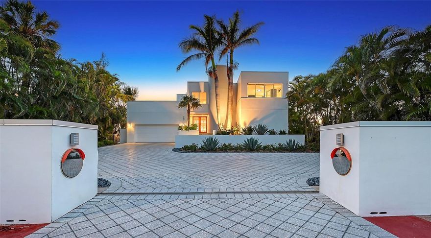 Owner Will Entertain Offers. A Rare Waterfront Sanctuary on St. Armands – Unrivaled Views, Elegant Design, Exceptional Location. Perfectly positioned on 110 feet of boating water, this stunning coastal modern residence offers captivating open views of Pansy Bayou with a rooftop glimpse of the Gulf of Mexico. Just two blocks from the world-class dining and boutiques of St. Armands Circle and moments from the sugar sands of Lido Beach, this home blends architectural elegance with effortless coastal living. Floor-to-ceiling windows and soaring ceilings flood the interior with natural light, showcasing breathtaking water vistas from nearly every room. Thoughtfully designed for both everyday comfort and grand entertaining, the open-concept layout features 4 spacious bedrooms and 4 bathrooms—including a luxurious primary suite with a private sunroom/home office. The kitchen is a chef’s dream, outfitted with top-of-the-line Thermador appliances, including a professional-grade 6-burner gas range, wine cooler, and newer refrigerator. Outdoor living is equally impressive with a resort-style pool deck, lush mature landscaping, and a rooftop terrace offering unforgettable sunsets over the Gulf. Meticulously maintained and move-in ready, the home includes a new roof (2024), recently replaced seawall (2017), dual-zoned Rheem A/C systems, electric hurricane shutters, whole-home speaker system, and a secure gated entrance for ultimate privacy and peace of mind. FEMA-compliant with the main living level elevated 12.1 feet above base flood elevation, this property offers both safety and sophistication. Located directly across from a protected bird sanctuary, this peaceful retreat is a haven for nature lovers—where dolphins and manatees are frequent visitors.