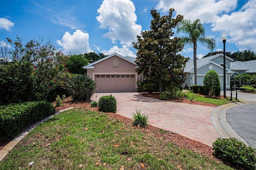 Set back on a private lot along a peaceful cul-de-sac, this stunning villa is encircled in pavers accented by lush landscaping; the community is gated. The grand foyer reveals the spacious living room's vaulted ceilings, architectural niches, crown molding, and gleaming porcelain tile floors. A formal dining room features a set of french doors providing entry to the spectacular screened lanai boasting ample square footage to relax, dine alfresco, and host your family's special events and holidays. Multiple sets of sliders not only provide entry from several rooms but lend plenty of natural light. Curved archways and a rich color palate lend ambiance to the recently UPDATED kitchen. Sleekly designed, recessed lighting shines down on granite countertops and the ample storage, courtesy of the cabinetry and its pullout drawers. A lovely window dressed in plantation shutters graces the adjacent breakfast room. The master suite was also recently UPDATED. From the shower room and built-in vanity to the garden soaking tub, you'll relish this retreat and love the two walk-in closets. The second bedroom and its bath are also well appointed. A large den is currently used as an office, but its decorative set of doors and large window lend a versatility to designate this choice space as a personal fitness/yoga center, library, or home theater. A NEW roof was installed in 2018. The HOA covers exterior maintenance including lawn, trees, bushes, exterior painting, basic cable, trash, and the sparkling community pool. Nestled in the Villages at Fox Hollow, this well-maintained residence is close to the area's restaurants and retail, as well as the countless golf courses and parks, along with all the coastal beauty from Honeymoon State Park to Clearwater Beach to the cultural center that is Tampa. Trinity is the gem of Pasco County.
