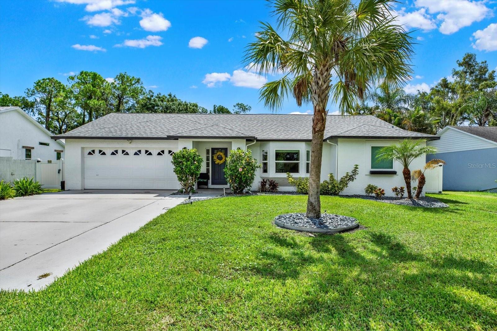 Welcome to this BEAUTIFUL, updated 3-bedroom, 2-bathroom, 2-car garage home located in the highly sought-after Cedar Woods community of Pinellas Park! This meticulously maintained residence offers a spacious open-concept, split-bedroom floor plan with VAULTED CEILINGS AND LUXURY LAMINATE FLOORING throughout. The stylish kitchen is a chef’s dream, featuring sleek stone countertops, a breakfast bar, pantry and stainless-steel appliances. Entertain with ease in the expansive living room, family room and formal dining area. The generously sized primary suite boasts a LARGE WALK-IN CLOSET and a spa-like ensuite bathroom complete with marble floors, walk-in shower and a luxurious soaking tub. Two additional bedrooms are well-appointed and share a beautifully updated full bathroom with dual sinks. Additional highlights include a LARGE INTERIOR LAUNDRY ROOM, water softener, reverse osmosis system in the kitchen, and a full security system with cameras. Enjoy ultimate privacy in the fully fenced backyard, featuring a screened-in porch, cozy fire pit, and ample space to add a pool. Major updates include NEW ROOF, A/C, and WATER HEATER (all 2021) plus HURRICANE IMPACT WINDOWS AND DOORS THROUGHOUT! Ideally situated close to top-rated beaches, shopping, downtown St. Petersburg, Tampa, and more. NO FLOOD DAMAGE FROM HURRICANES! Don’t miss this exceptional opportunity—schedule your private showing today!