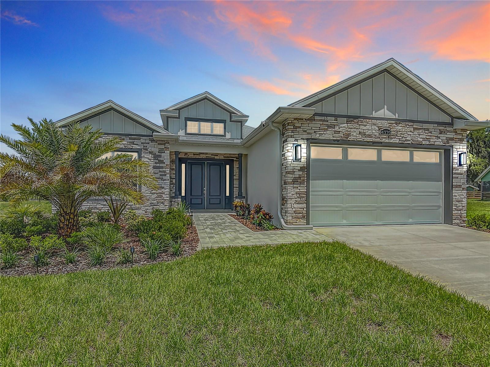 One or more photo(s) has been virtually staged. BRAND NEW - NEVER LIVED IN NEW CONSTRUCTION on 1.16 acres- Introducing the Luka model, a single-story home offering 2,064 square feet of elegant living space. This open-concept home features three bedrooms with closet organizers, a great room, dining and kitchen. It includes two spacious bathrooms fully tiled with 24 x 48 porcelain tiles and a large laundry room with ample closet space. The Luka model comes equipped with a refrigerator, range, microwave, dishwasher, washer, dryer, and garbage disposal. Additional upgrades include 10-foot ceilings with crown molding throughout, 8-foot doors,7 x 47 plank porcelain tiles, a paver driveway, and more. You will awed by the 15ft tall foyer, open floor plan, roominess and spacious, open areas! Light color decor/lighting throughout, no carpet, gorgeous quartz countertops, light cabinetry, stainless steel kitchen appliances, custom tile bathrooms and showers, crown moulding throughout entire home, large primary suite with custom closet shelving, large screened lanai on the rear of home designed for summer kitchen! Front of home features a stone facade, gorgeous landscaping and palm tree, all on OVER ONE ACRE lot on paved street, room for a pool or RV port, garden, or space for the hobbyist. Convenient location close to Wildwood, The Villages, and Belleview. This home is ready to move in so you can enjoy Florida living at it's very best!