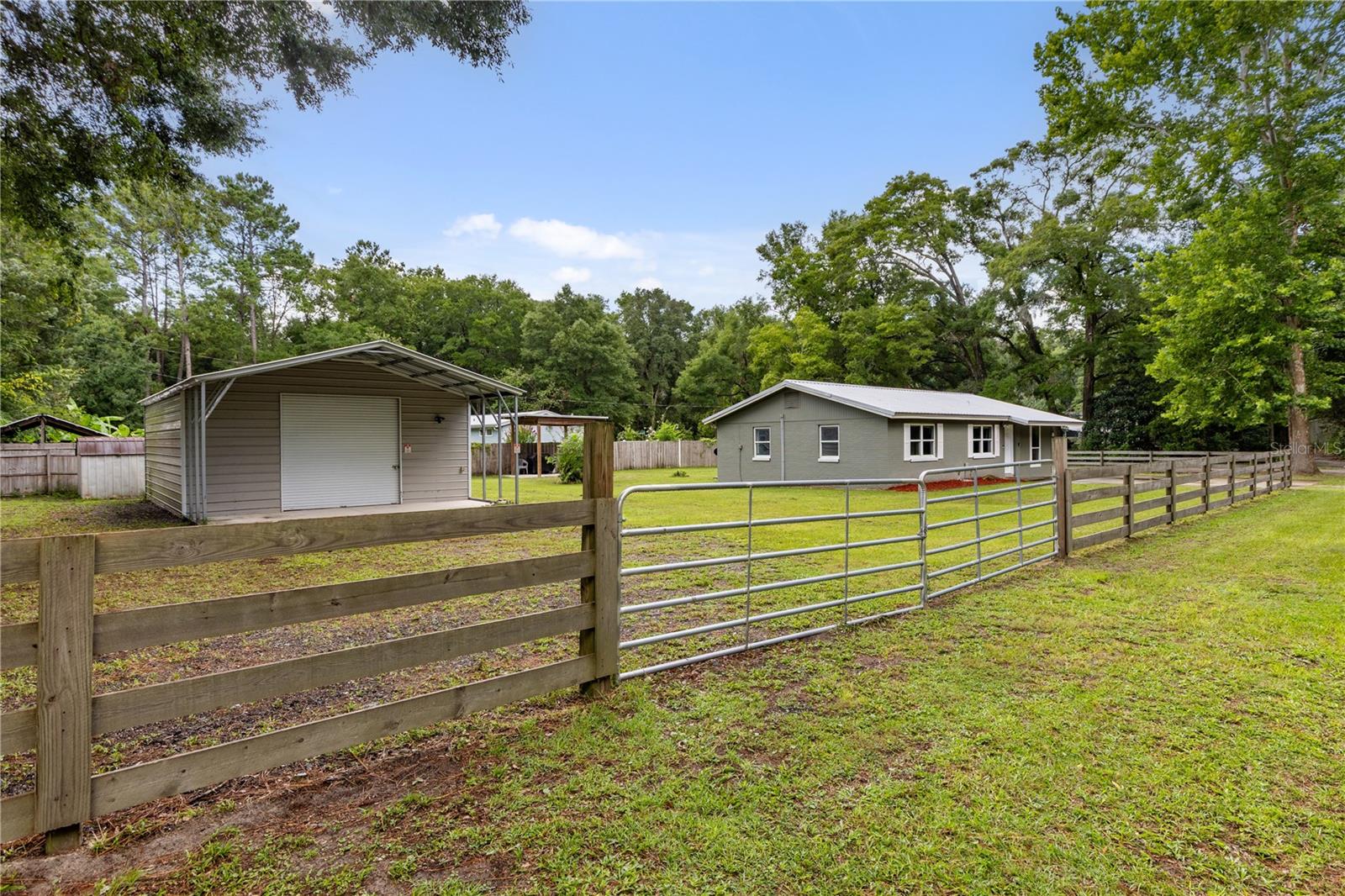 Welcome home to this updated block home, perfectly positioned just minutes from charming downtown High Springs! This inviting property features a fully renovated kitchen and bathroom, showcasing upgraded cabinetry and fixtures, modern countertops, updated windows, metal roof in 2019, and a spacious indoor laundry room for added convenience. The home sits on a fully fenced lot and includes a large 25'x30' metal building, perfect for hobbies, storage, or workshop space. Nature lovers will appreciate proximity to the beautiful Santa Fe River and nearby springs, including Poe Springs, Gilchrist Blue Springs, and Ginnie Springs—all just minutes from your doorstep.
This home is an active short-term-rental and performs well! Showings by appointment only.