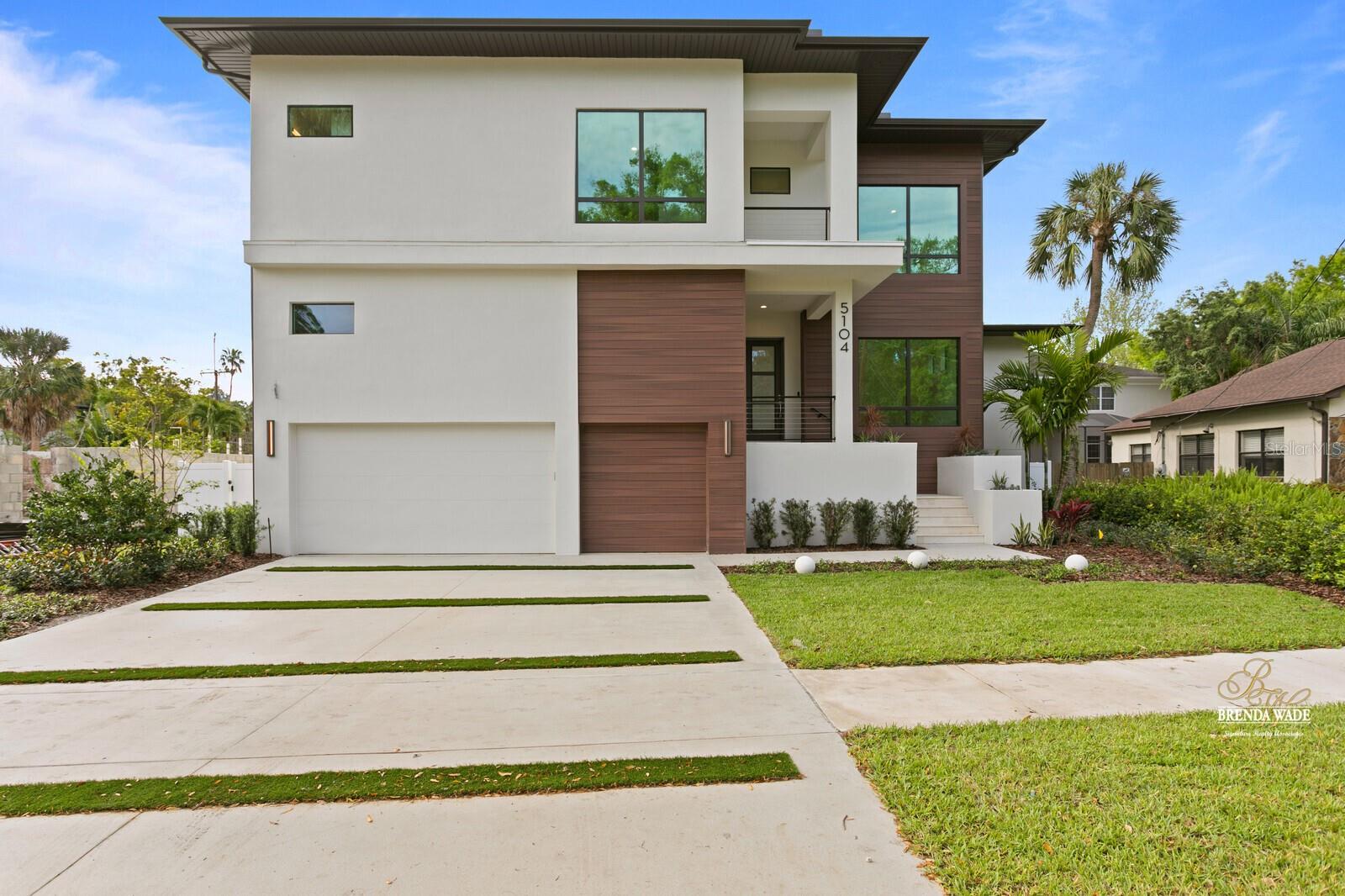Contemporary Elegance in Coveted Beach Park. Discover refined living in this stunning custom home in South Tampa’s distinguished Beach Park neighborhood. With over 4,700 sq ft of thoughtfully designed space, this modern residence blends clean architectural lines with high-end finishes throughout. Step inside to 10-foot ceilings, wide-plank wood flooring, and abundant natural light from hurricane-impact windows. A dramatic glass-enclosed wine room, private study with full bath, and open-concept living spaces set the tone for effortless luxury. The chef’s kitchen impresses with Wolf and Sub-Zero appliances, quartz countertops, a butler’s pantry, and wine fridge—seamlessly connecting to the great room and dining area. Slide open the doors to an inviting outdoor retreat featuring a heated pool, travertine lanai, summer kitchen, and outdoor shower. The main level also includes a spacious guest suite, while upstairs you'll find a luxurious owner’s retreat with a spa-style bath and custom walk-in closet, plus three additional en-suite bedrooms and a versatile bonus room. Additional features include a mudroom, epoxy-coated 3-car garage, elevator shaft, and prewiring for generator, EV charging, and smart home systems. 5104 W Evelyn Drive is a rare opportunity to own a home where design, function, and location converge beautifully.