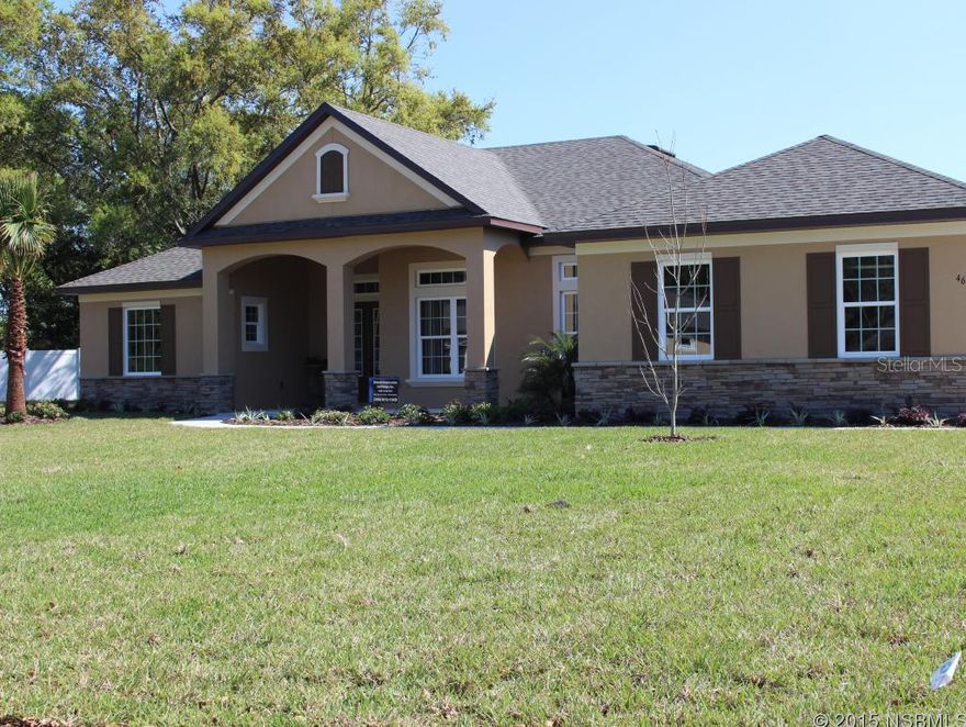 UNDER CONSTRUCTION. 3 bedroom, 2.5 bath in prestigious golf course community of Sugar Mill. 18x18" Porcelain tile floors throughout, main living areas and all walkways. Carpet in bedrooms. Dual granite vanities in master suite. Separate shower, plus soaker tub with designer Porcelain tile. 12' ceilings in foyer and dining room with tray ceiling in living room. Walk-in closet off master. Custom kitchen cabinets with clove stain and licorice glaze. Glass accent doors, pop-up cabinets and built-in stainless steel appliances, including microwave gas range and walk-in kitchen pantry. Custom cabinets in laundry room with separate laundry sink and storage closet. Low E Vinyl windows for energy efficiency.  Pocket sliding doors from living room to Lanai. Natural gas with tankless water heater. Natural gas fireplace with stone accents on lanai, great for outdoor living. Natural gas grill built-in, summer kitchen, with exterior stainless steel vented hood. Sink and space for future refrigerator outside.  Upgraded lighting and prewires throughout home. 3 car side entry garage with pull-down ladder attic access and Coach lighting. Covered front porch with columns at entry and stone accents. Yard to be fully sodded and irrigated. ;Water: City