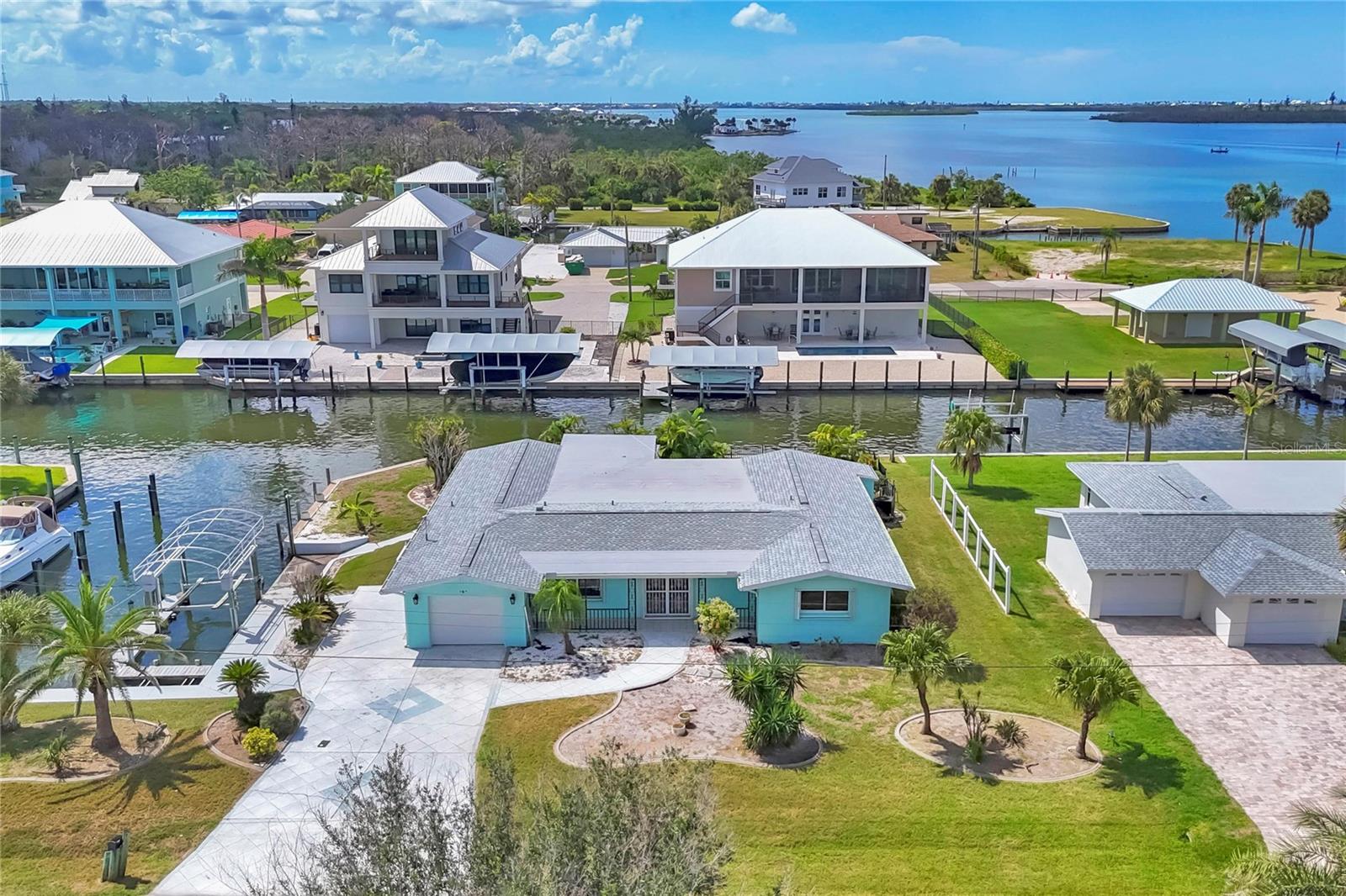 This waterfront home offers the perfect blend of location and potential, with quick and easy access with no bridges to Lemon Bay, Stump Pass and the Gulf of America for unbeatable Boating and Fishing. Featuring a private pool, and dock with boat lift, this property is a dream for water lovers. This unique property is situated on an extra large lot with a desirable south facing backyard. A very unique side cut in for extra large boats, and ample storage space for all of your boating needs. Some recent updates are newer seawall, and a new roof in 2022. The home sustained damage from the recent storms and now presents a blank canvas for you to design and customize to your taste, whether you’re looking to create a coastal retreat or a full-time waterfront paradise, this is your chance to bring your vision to life in an unbeatable location.