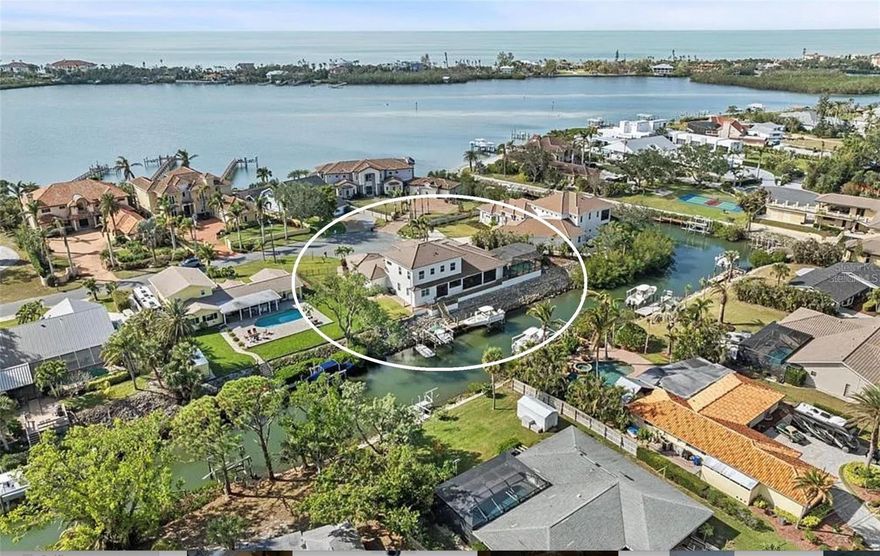 Experience the ultimate boating lifestyle from this custom-built waterfront home on a peaceful cul-de-sac.
Sitting high and dry at 12 feet, the home was fully renovated for it’s current owners in 2020. Built well after the 2002 Florida Building Code changes (which required structures to be engineered for improved hurricane resistance, including impact windows, elevated designs and a more stringent building code), gives you peace of mind and makes the home easier to insure than an older home.
An elegant design featuring high ceilings and engineered hardwood floors leads to a stunning outdoor retreat. The home's extensive glass windows and sliding doors create a seamless transition to your oversized entertainment area and screened lanai. This outdoor oasis features a heated saltwater pool, outdoor kitchen with Alfresco built-in grill, built in speakers, propane fireplace and TV—ideal for entertaining against the canal backdrop. With 190 feet of waterfront, one house away from the intracoastal, and no fixed bridges to the Gulf, this property is a boater's paradise. Featuring a 10,000 lb primary boat lift, a 5,000 lb double jet ski lift, a fish station, and a 70-foot Trex dock equipped with water and power.  Whether you prefer boating, kayaking, paddleboarding, fishing, or simply lounging by the pool, this outdoor space is designed for all-day enjoyment.
The chef's dream kitchen was fully remodeled in 2020 with both serious cooks and entertaining in mind, showcasing double islands, quartz countertops, and top-of-the-line Wolf/Subzero appliances, including an induction cooktop, convection microwave, convection steam oven, wine fridge, and an oversized built-in refrigerator. A walk-in wet pantry with an ice maker and espresso machine hookup completes this culinary haven.
The luxurious main floor primary suite features a spa-like bathroom with a double showerhead walk-through shower, a jetted soaker tub, double sinks, and three spacious walk-in closets. Enjoy the seamless transition to the pool area through French doors, or retreat to the connected office adorned with smart electric blinds and built-in desk and cabinetry.  
Upstairs you’ll find two oversized bedrooms, each with its own full ensuite and a loft area with vaulted ceilings and a wet bar. The upstairs provides complete privacy for your family or guests.
Every detail has been carefully crafted, from the tray ceilings and crown molding to engineered hardwood floors and LED lighting. Even the 4 car garage has built in storage, a work bench, high ceilings, epoxy floors and 2 EV charging ports!
Recent upgrades include exterior painting, a new flat tile roof at the end of 2023 (these upgrades alone were over $118,000).  With all major updates already done, there is nothing left to do but move in and enjoy this exquisite waterfront retreat.  Schedule your private tour today.