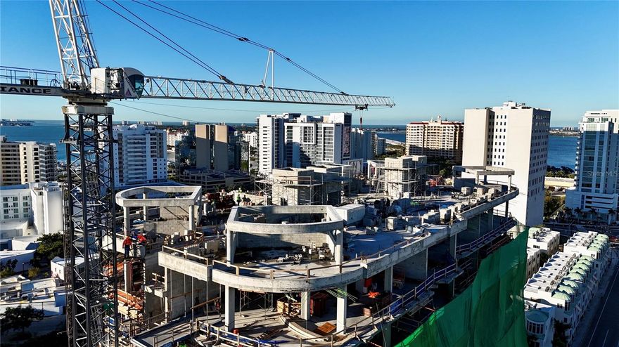 Under Construction. The Edge Sarasota embodies refined urban luxury in the heart of downtown’s vibrant Arts District. Residence B is an impeccably designed 3-bedroom, 3-bathroom corner residence offering over 3,500 square feet of living space, framed by floor-to-ceiling windows and sweeping city views from the 8th floor. The open-concept design features soaring ceilings, walls of glass and a chef’s kitchen with Italian cabinetry, Wolf and Sub-Zero appliances including a gas cooktop, an expansive island with waterfall edge and a butler’s pantry—all curated for elevated living. From the great room, dining or separate living room step out onto your private terrace and feel the energy of Sarasota below while enjoying the tranquility of your own modern sanctuary. The owners’ suite provides a true retreat with a gracious foyer, midnight bar, dual walk-in closets and en suite bathroom featuring dual vanities, private water closets, glass enclosed shower, soaking tub and convenient linen closet. A full laundry room with front-load washer and dryer and utility sink includes additional storage for ease of living.  
Beyond your residence, enjoy a curated collection of luxury amenities including a resort-style pool deck with hot and cold plunge pools, cabanas and two outdoor kitchens. The owners’ club focuses on wellness and entertainment with a fully equipped fitness center complete with a yoga room and infrared sauna. Two treatments rooms afford plenty of space for your personal massage therapist or a physical therapy session. The social room includes a lounge, bar, game room and catering kitchen. For more intimate gatherings, reserve the private dining room featuring resident wine lockers and a separate bar area. The building’s boutique size—only 27 residences—creates a community feel in the heart of Sarasota’s vibrant Arts District. Walk to acclaimed restaurants, galleries, boutiques, and the Bayfront, embracing a lifestyle that combines culture, convenience, and sophistication. Construction is progressing with limited opportunities to customize your finishes—secure your place at The Edge today and invest in a rare downtown Sarasota address with lasting appeal. Images shown are artist renderings intended to illustrate the interior finishes and design concepts for this community.