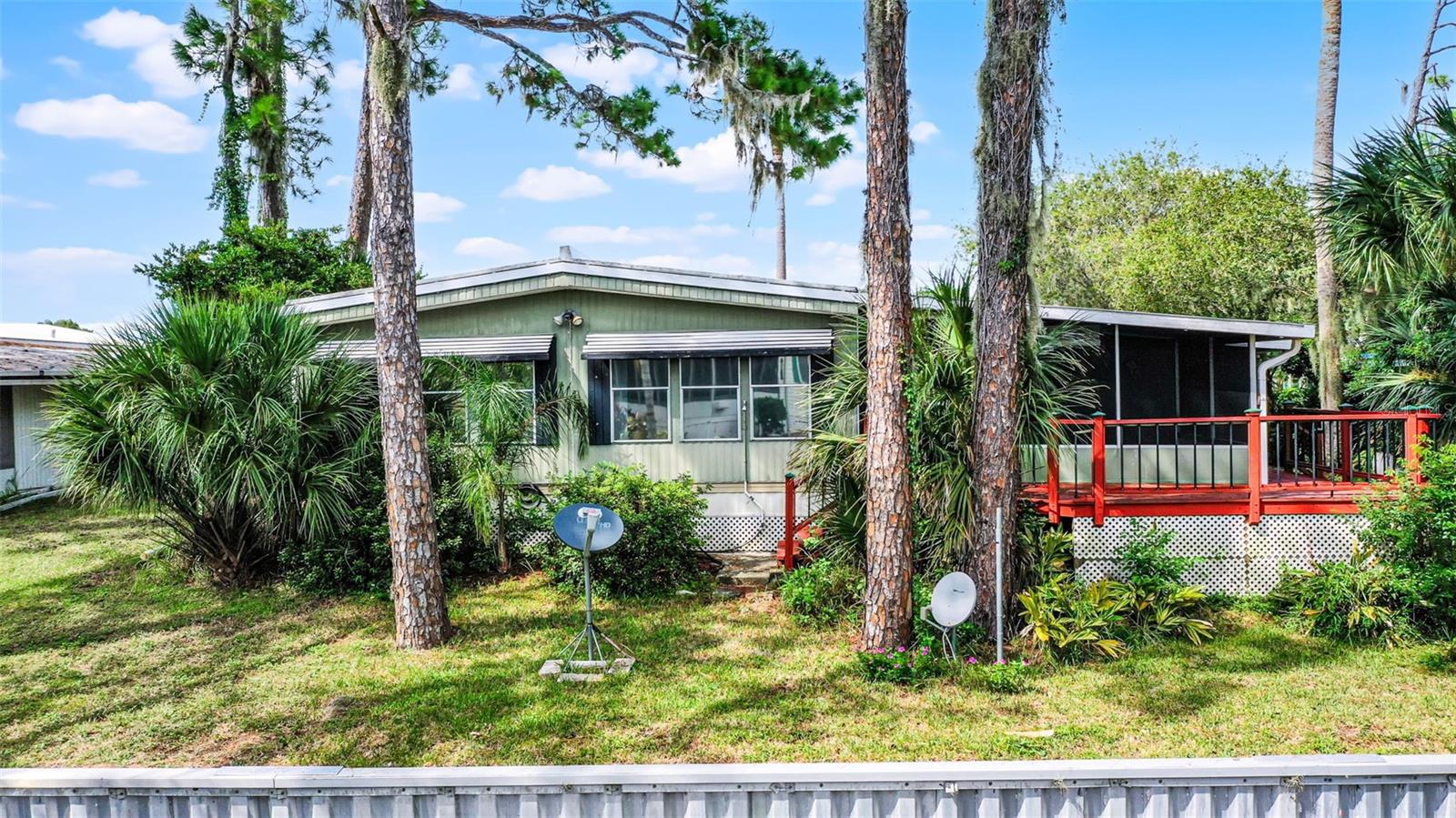 Welcome to 192 Palm Meadows, a well-maintained 3-bedroom, 2-bath home in the highly desirable 55+ waterfront community of Country Club Manor in Eustis, FL. Tucked away in beautiful Lake County, this home offers peaceful living with convenient access to Mount Dora, downtown Eustis, and The Villages — plus easy travel throughout Central Florida via the new 429 expressway extension. This spacious home features a split floor plan, open living and dining areas, a bright kitchen, and a large primary suite with a walk-in closet and private bath. There’s also a bonus area perfect for a home office, craft room, or extra storage. The screened-in Florida room provides a great spot to relax and unwind. Enjoy canal access to Trout Lake, perfect for kayaking, fishing, or simply enjoying the tranquil views.
Country Club Manor offers a vibrant social lifestyle, including bingo nights, potlucks, shuffleboard tournaments, holiday events, and more — all centered around the community clubhouse and private lakefront setting. The co-op fee is $231/month and includes water, sewer, and trash service. Don't miss this chance to enjoy affordable, active adult living in one of Eustis's most welcoming communities. Schedule your private showing today!