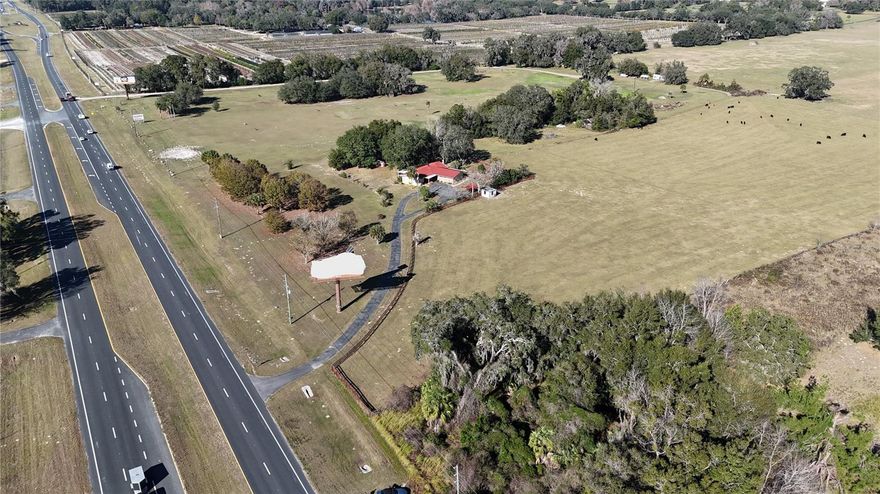 This versatile 6.79+/- acre property offers prime frontage along Highway 484, conveniently located between Ocala and Belleview. It is surrounded by established businesses and is poised for future growth. The property includes a 3-bedroom residence, featuring two bedrooms within the main house connected by a breezeway to a separate ensuite bedroom. Additionally, the property boasts lush green pastures and an income-generating billboard. The property is ideally situated near Florida Greenways and Trails and the Florida Horse Park. This is a rare opportunity that combines an excellent location with flexibility and income potential. Located just two miles from Interstate 75.