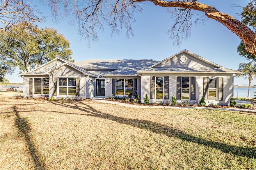 Lakefront living on nearly an acre—welcome to 411 Edgewater Dr. in Polk City. Set on a rare .83-acre waterfront lot with approximately 205 feet of frontage on beautiful Lake Agnes (home to Fantasy of Flight), this fully updated pool home is the kind of Florida lifestyle property that doesn’t come around often.  Step out back to a screened-in pool and expansive lake views with an eastern exposure—perfect for sunrise coffee, bright mornings on the water, and shaded afternoons by the pool. With ample shoreline, the buyer has the opportunity to add a private boat dock and truly create the ultimate lakefront retreat.  Plenty of parking with space for a boat or RV.  Inside, the home is turn-key and move-in ready with tasteful updates throughout. Energy film on the windows helps reduce heat load and glare, keeping the interior comfortable while preserving those incredible water views.  Conveniently located between Lakeland and Orlando with quick access to I-4, you’re positioned for easy commutes to Orlando, Lakeland, and Tampa—and it’s also just about a half-hour drive to Walt Disney World Resort—while still enjoying the peace and space of lakefront living.