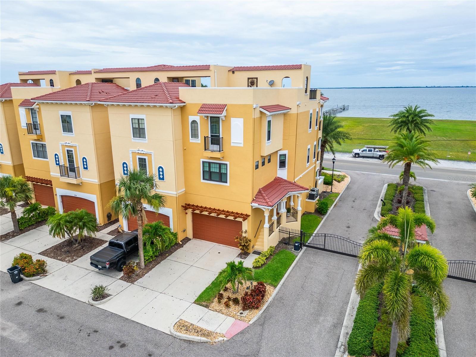 Luxury Waterfront Corner Townhome with Panoramic Views of Beercan Island! Welcome to 6412 Mayra Shores Ln, a beautifully upgraded corner-unit townhome in the heart of Apollo Beach. This luxury residence offers extra yard space, unobstructed views of the water, and stunning vistas of Beercan Island. With dual rooftop patios—one in the front and one in the back—you’ll enjoy endless opportunities to relax, entertain, while taking in the breathtaking scenery. As you enter the home, you’re greeted by soaring ceilings, elegant crown molding, and a light-filled layout that creates an open and airy ambiance. The seller has spared no expense, investing over $50,000 in recent upgrades. In 2023, a brand-new flat roof was installed with a 10-year warranty. In 2024, the home was further enhanced with hurricane-rated windows and sliders featuring a transferable lifetime warranty, a new hot water heater, and new flooring on the first floor and in the master bedroom. Thoughtful touches like custom accent walls add warmth and style throughout. Upstairs, you’ll find two spacious living areas on the second floor, offering flexibility for lounging, entertaining, or creating a home theater or office space. Just outside your door, you’ll find two marinas across the road, along with a variety of upscale waterfront restaurants—perfect for enjoying the Florida lifestyle. Have peace of mind knowing the HOA covers all landscaping and exterior maintenance, as well as access to the community pool, plus sewer, trash, and water services. Whether you’re gathering with friends, spending time with family, or simply enjoying the peaceful surroundings, this home provides the perfect backdrop for luxurious waterfront living. Don’t miss your chance to own this one-of-a-kind property in a prime Apollo Beach location.