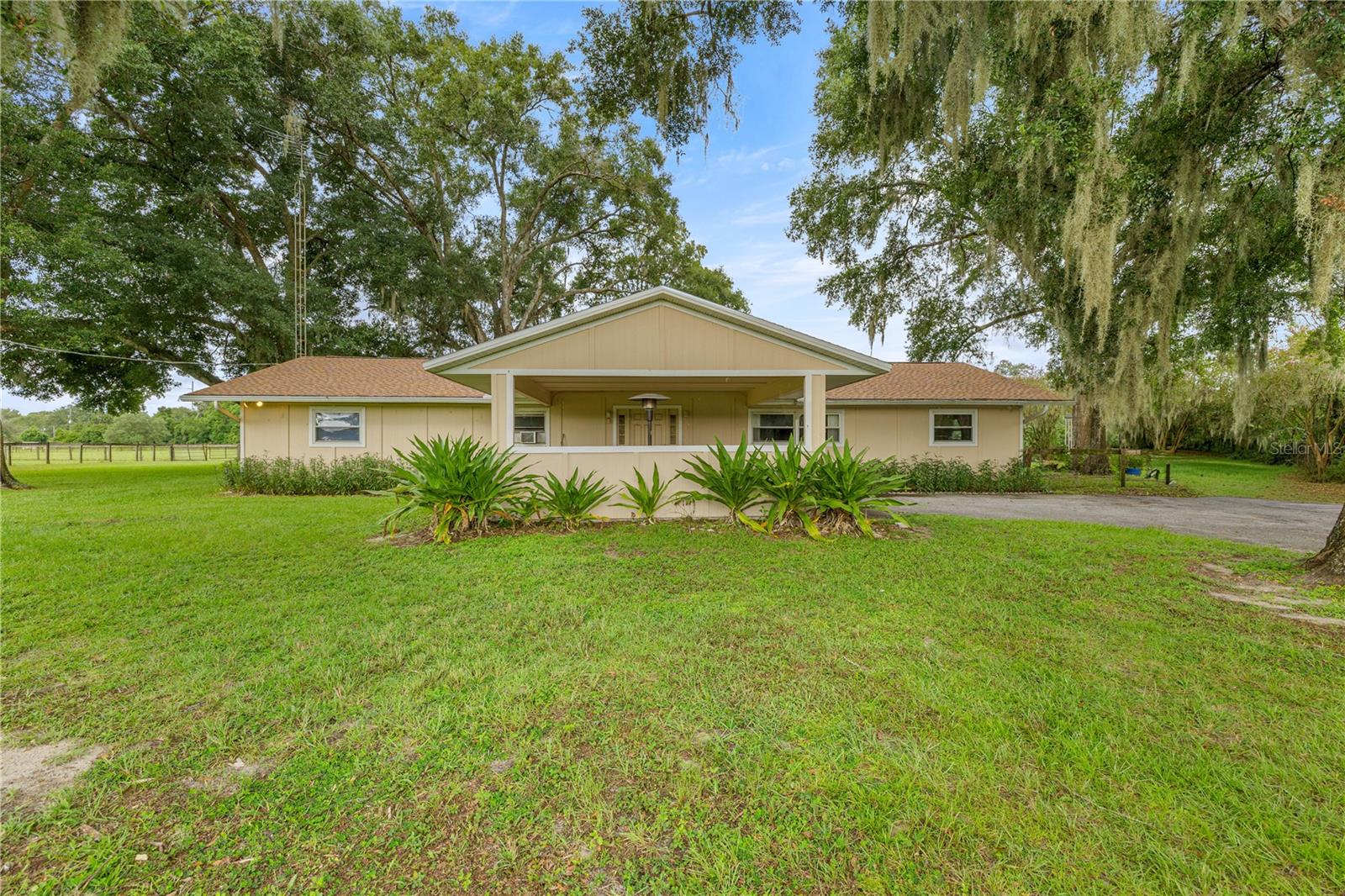 Gorgeous mini farm in an incredible location! This property offers lots of options. The main home is a 2672 sq ft, 4 extra large bedrooms 2 bath home. It features a huge enclosed Florida room with lots flexabilty. The home has double paned windows, LARGE KITCHEN, NEW Roof 2023 and a 2021 AC. There are 2 other structures on the property as well. One could be an IN LAW home or an OFFICE BUILDING. It also has 900 sq ft that could be storage or kennels and dog runs and stalls for goats or miniature horses. This 768 square foot building has an office, kitchen, bathroom and bedroom and is concrete block construction. The 5 stall barn has water and interior and the stalls are 10'X11'. There are 3 large fenced and watered pastures as well as a round pen. The property has 3 septic tanks and 2 wells. The main house is equipped with a whole house generator, tank holds 400 Gallons of propane which is currently full. This farm is centrally located between the Villages and Ocala and surrounded by other equine and farm propertiy. With just a 10 minute drive to the Florida Horse Park and Marjorie Harris Carr Cross Green Way & trails, 30 minutes from the World Equestrian Center this property is in the heart of it!! The property is completely fenced and ready for you to make it your dream.