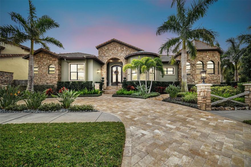 If you are looking for a non-cookie cutter (just sheet rock / texture and paint) custom built home with extreme amounts of character in all rooms, this might be your home…This home was built with an unlimited budget.  Through front double doors into a round stone foyer with massive ceilings with large beams and stone inlaid in wood flooring… from there you will find barrel wood crafted ceilings, incredible lighting fixtures. Over the top trayed ceiling with massive beams.   Stone and real wood on all floors, only 1 brand new piece of carpet under Master bed.  See for yourself, scroll the pictures or watch the video.  Tons of chosen granite in the bar and chef’s dream kitchen, wall oven, range range hood, top end appliances, two dishwashers.  Wet bar consist of two frigeration drawers, wine cooler, ice maker and dishwasher.   Copper tub in the Master with double entry shower.  Walk in closet is dreamy with massive amounts of storage, wall of storage for shoes, built in dresser, plus additional custom built closet, all perfect to show case your treasures, also has additional stackable washer / dryer if desired.  Three bedrooms have ensuites, three walk-in showers, 2 soaking tubs.  Massive glass sliders to open up the complete living room to entertain guest on patio overlooking the incredible pool equipped with gas lanterns.  Rear is privacy fenced.  New water treatment system placed in last 18 months or so.  Three car garage, climate controlled with mini-split and additional golf cart parking cabana.  Drive way all pavers as well as inside of garage. Real Estate Broker Owner is positive this home could not be built anywhere near asking price.