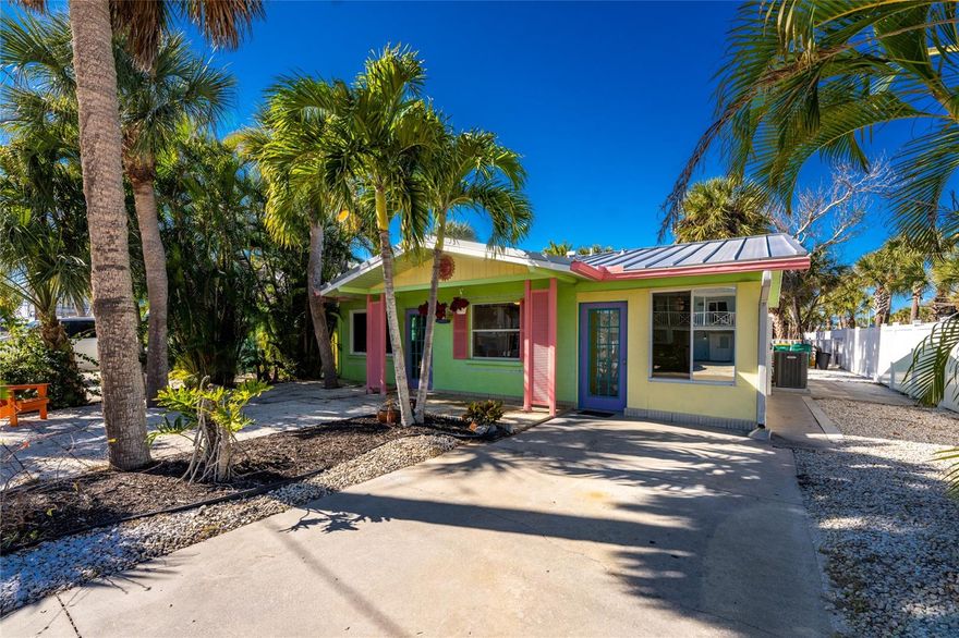 One or more photo(s) has been virtually staged. -- MANASOTA KEY -- this charming updated island cottage sits on a corner lot just a stone’s throw from the beach and Gulf of Mexico. Enjoy partial Gulf views from the front yard and easy access to the beach for sunsets, swimming, and coastal wildlife. Fully tiled throughout, this home includes an all-new kitchen & bathroom cabinets, countertops, stainless steel appliances, and all new interior trim, doors & hardware. The attached 10'x19' Florida room adds flexible living or dining space, and the rear screened, covered lanai offers a private setting overlooking the partially fenced backyard. Other notable and recent upgrades include: new standing-seam metal roof installed May 2025, new electrical panel and upgraded wiring in most of home 2024, new A/C in 2024 and new water heater. Home also includes a wood-burning fireplace perfect for those crisp evenings. Enjoy the convenience of a private, fully enclosed outdoor shower—perfect after a beach day. Indoor utility room includes a half bathroom and new full-size washer/dryer. This home would be ideal as a personal retreat or rental property, providing excellent flexibility near the beach. Additionally, this property offers sidewalk access to nearby island restaurants and shopping and is less than one mile from Stump Pass Beach State Park. Your coastal retreat awaits!