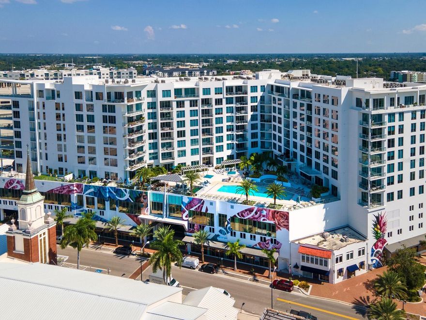 This high-floor residence at The Mark offers enhanced value with exceptional design and technological upgrades throughout every room. Upgrades exceeding $200,000 include luxury flooring, custom built-in cabinets and beds, carbon water filtration and smart lighting and window shades for convenience and efficiency. This beautiful and functional space has been occupied only by the original owners since the completion of The Mark in 2019. A spacious floor plan spans more than 2,200 A/C square feet, encompassing an open living and dining area, as well as three large en-suite bedrooms that easily accommodate a family or generous hospitality. From the entry, beautiful wood plank floors lead to the brightly lit main living space with floor-to-ceiling windows welcoming expansive views of the cityscape and eastern horizon. Adjacent to the dining and sitting areas, a sleek kitchen overlooks a large private terrace with full-height sliding doors that showcase unobstructed views and open to additional lounge and dining space. The kitchen features premium stainless steel appliances, including JennAir refrigerator, dishwasher, and induction range, as well as KitchenAid beverage drawers. An oversized island with quartz countertop offers both ample seating and prep space, with a modern pendant light complementing the chic modern cabinetry.
The master suite is a private oasis with beautiful views and a walk-in closet that includes a built-in bureau for ideal storage. The master bathroom features two separate vanities, a glass-enclosed walk-in shower, and separate water closet. In one of the additional bedrooms, built-in queen bunk beds double the sleeping space, and a built-in desk adds function for work or study. Each of the ensuite bathrooms features premium finishes and fixtures, and one includes a bathtub that adds convenience for families. In addition to the three en-suite bedrooms, a separate media den offers flexible space for private office use or occasional guest space. A dedicated laundry room with utility sink adds both function and storage. Additional features that enhance this living space include both recessed lighting and premium ceiling fixtures, built-in storage in living, dining, and bedrooms, and elegant neutral tones that complement the modern architectural style. A second dedicated parking space adds even more value. Known for its style and location, The Mark is the perfect address for enjoying Downtown Sarasota. Newly constructed in 2019, amenities include a pool and spa, shared deck with grill station, internet café, and 24-hour security. Next to restaurants, shops, and the farmers market, as well as a trolley stop, all of Sarasota is at your doorstep in this luxuriously designed home. Furnishings available by separate agreement. Room Feature: Linen Closet In Bath (Primary Bedroom).