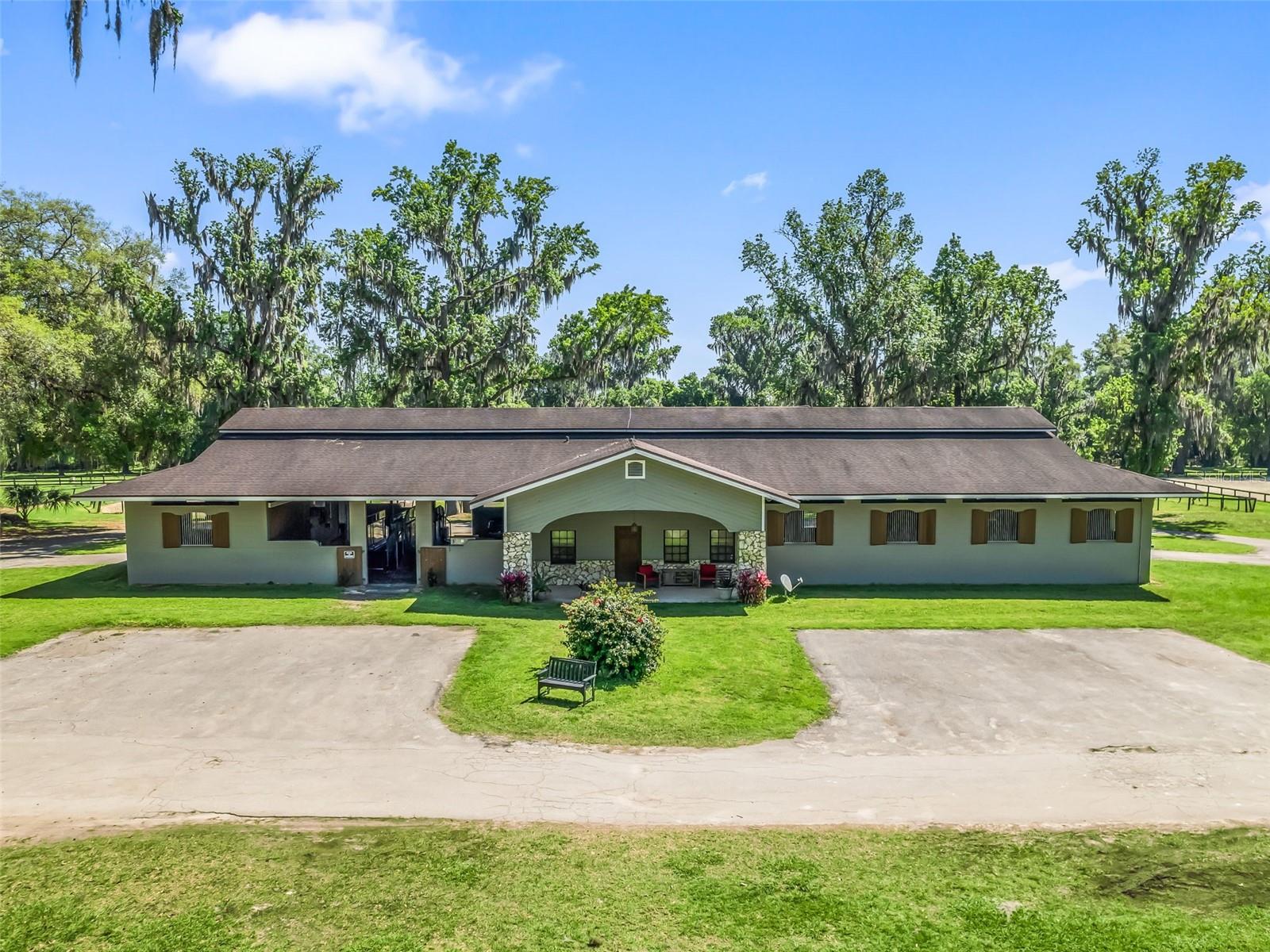 Welcome to 8475 NW 60 AVE! This property sits on 32+/- acres and is nestled in the heart of NW Ocala only 10 minutes from the WEC and just minutes from I75. This outstanding property stands out in the area for its rare offering of 30 stalls, distinguishing it from others nearby. Three different barns offer various options for the new owner. They can choose to use one of the barns themselves and have the opportunity to lease out the stalls in the other two. Main CB barn features 10 OVERSIZED stalls, storage/laundry space, wash-rack and a barn studio apartment with bull bathroom and small kitchen for groom's living quarters. Second CB barn just next to it features 12 stalls with office space, tack room, feed room and wash-rack. Last but not least, a third framed barn with 8 additional stalls and small tack room that has just been refurbished. Just a couple of strides from the main barn you'll find a spectacular Full Draining base Arena with GGT Footing measuring 125 x 230. Arena was completed in 2021. Farm also posses a loading chute 3/8 +/- mile grass conditioning gallop, this track is a fantastic asset to the farm as it is perfect for galloping. House features 2 RESIDENCES with two separate entrances and two separate kitchens. Main home provides and open layout with 3-Bedrooms, 3-Bathrooms and an office. Just outside there views to the scenic farm and pool where you can enjoy gatherings and a great opportunity to enhance AIRBNB listings. Second home is a two story 2-Bedroom, 2.5-Bathroom perfect for rental purposes or for larger families with needed space. A/C units are new from 2021/2022. PAdditionally the farm counts with 2 RV hookups. The income potential is unlimited. Don't miss our on this rare opportunity and call to schedule a showing!