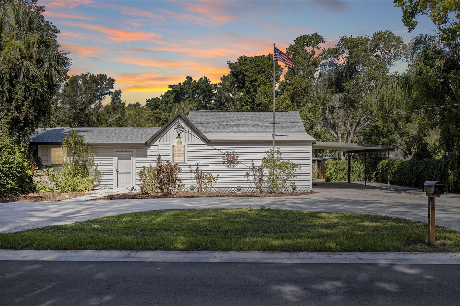 Welcome to this 3-bedroom, 2-bath home in the heart of Largo! Sitting on OVER HALF AN ACRE of land, this house offers the rare combination of privacy, space, and natural beauty. The true gem of this property is the SPRING-FED CREEK that winds through the backyard, creating a picturesque setting with the potential to transform into a peaceful pond. Imagine building a quaint little bridge over it and creating your own picnic or relaxation spot—perfect for nature lovers and those seeking a one-of-a-kind outdoor lifestyle. With room for chickens and goats, this property offers a taste of country living with all the conveniences of the city just minutes away. The home has been thoughtfully updated with a BRAND-NEW ROOF (2025), HVAC system (2025), and WATER HEATER (2025). Inside, you'll find luxury vinyl plank flooring throughout and a beautifully updated kitchen featuring real wood cabinetry, granite and butcher block countertops, and NEW STAINLESS STEEL APPLIANCES! The bathroom boasts sleek quartz countertops and newly redone shower valves for a modern touch. The layout is both functional and spacious, with a kitchen and dining room combo, ample closet and storage space, and a large walk-in closet in the primary bedroom. The primary walk-in closet is so large, it could even double as an office space! The LARGE ATTIC space is a great opportunity for expansion! A separate utility room with laundry hookups adds convenience, and the screened-in porch offers a great place to relax and enjoy the outdoors. Two carports and the large circular driveway provide plenty of parking. Plus, this home is NOT IN A FLOOD ZONE! Within WALKING DISTANCE to the newly renovated Southwest Recreation Complex pool! With its expansive lot, rare natural water feature, and updated features throughout, this property offers incredible potential for someone ready to make it their own. Don't miss the opportunity to own a little slice of Florida charm with room to grow!