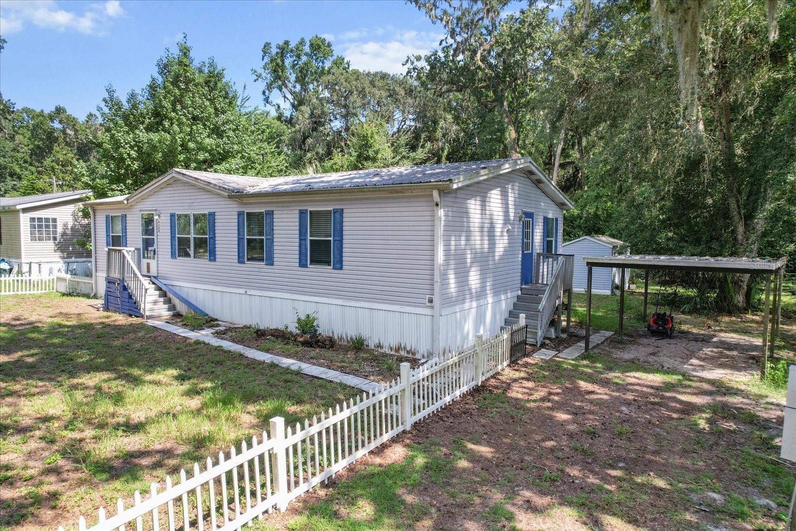 This charming 3-bedroom, 2-bathroom 2002 mobile home offers the perfect blend of comfort and convenience for nature lovers, weekend warriors, or full-time residents seeking a peaceful escape. Located just a quarter mile from the public boat ramp (at the end of Turner Camp Rd) - you'll have quick access to the Withlacoochee River. Set on 0.42 acres, this 1,296 sq ft home features a spacious and functional layout with a split bedroom floor plan, large kitchen with ample cabinetry, eat in space, dining area, and a cozy living room perfect for relaxing or entertaining. Outside, you'll appreciate the covered carport, storage shed, and plenty of yard space for boats, toys, or gardening. Whether you're launching your kayak at sunrise or hosting a backyard fish fry, this property offers an unbeatable location and lifestyle. No HOA and plenty of potential—bring your vision and enjoy all that Florida’s Nature Coast has to offer!