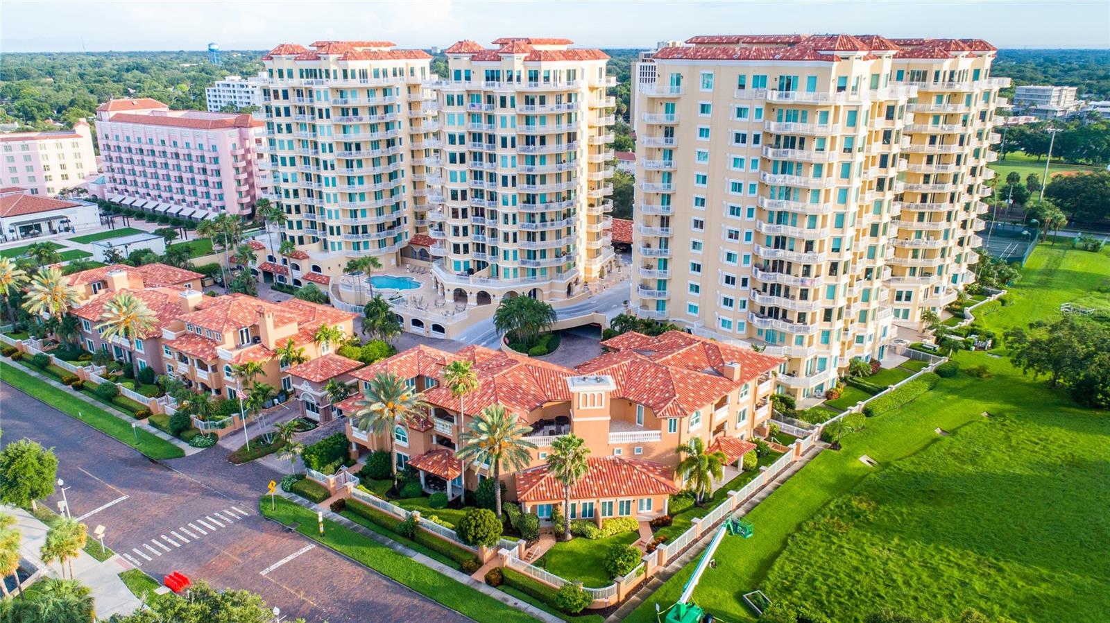 Under contract-accepting backup offers. Experience breathtaking sunrises and stunning views of the St. Petersburg Pier, Tampa Bay, the downtown St. Petersburg skyline, and the marina basin from three private terraces and every room in this expansive 3, 000-square-foot, 10th-floor condo with exclusive elevator access. This open-concept residence features three bedrooms, two and a half baths, and luxurious custom finishes throughout, all thoughtfully updated in August 2020. The beautifully renovated kitchen boasts wood cabinetry, a massive island with a concrete farmhouse sink, granite countertops, bar seating, a Sub-Zero refrigerator with matching cabinet panels, a wine refrigerator, and an induction range. The light-filled living room showcases panoramic water views and a stylish designer fireplace, perfect for entertaining. A large den or office space, complete with tray ceilings and recessed lighting, provides an ideal home workspace or additional living area. The master suite is a true retreat, offering built-in modern cabinetry, captivating views, a spacious walk-in closet, and sleek contemporary lighting. The en suite bathroom is a spa-like sanctuary, featuring granite countertops, elegant cabinetry, a glass-enclosed shower with a rain head and wand, and a large heated soaking tub. Two additional generously sized bedrooms, connected by a fully updated Jack-and-Jill bathroom, provide comfort and privacy for family or guests. Every detail in this one-of-a-kind residence has been meticulously curated, from the hardwood floors and crown molding to the custom built-ins throughout. Residents enjoy premium amenities, including two assigned covered parking spaces, heated pools, a fitness center, concierge services, and community spaces. Just under a mile from world-class dining, shopping, and museums, don't miss the chance to call The Vinoy home!