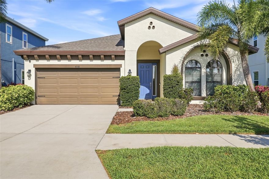Don’t miss this highly sought-after Sandpiper floor plan by Homes by WestBay, ideally located in the heart of Waterset. Enjoy a short walk to premier community amenities including the splash pad, dog park, indoor and outdoor fitness centers, amphitheater, playgrounds, multiple pools, waterslides, and sports courts. From the moment you arrive, the home makes a striking impression with its professional landscaping, new roof in 2025 and inviting blue front door. Step inside to a grand foyer with soaring 12-foot ceilings, setting the tone for the spacious and thoughtfully designed interior. To the right, you’ll find a secondary bedroom and guest bath—perfect for visitors. Just beyond, a versatile den with glass French doors offers the flexibility to serve as a home office or fourth bedroom.  On the left side of the home, an additional bedroom and a well-appointed laundry room feature white shaker cabinetry, a gas washer and dryer, and a utility sink. At the center of it all is the stunning kitchen, designed to delight any home chef. It boasts 42-inch white shaker cabinets, under-cabinet lighting, a glass subway tile backsplash, granite countertops, a gas range, and an oversized island with seating—ideal for entertaining. New owners will appreciate the updated microwave, dishwasher, and refrigerator, all replaced in 2025.  The kitchen flows seamlessly into the open-concept dining and living areas, highlighted by wood-trimmed windows that add a touch of craftsman charm. Large sliding glass doors lead to the covered lanai, creating an effortless indoor-outdoor living experience.  Step outside to your private, tropical backyard retreat, complete with uplighting on palm trees and solar lighting along the fence—perfect for enjoying peaceful mornings or relaxing evenings at sunset. The owner’s suite is a true oasis, featuring two spacious walk-in closets with custom organization systems. The en-suite bathroom offers a large walk-in tiled shower with a glass enclosure and dual vanities topped with granite countertops. Additional highlights include custom shelving installed in the two-car garage, providing ample overhead storage. Ideally situated near shops and restaurants, this home is part of a vibrant, active lifestyle community. Come experience everything this exceptional Waterset home has to offer—both as a beautiful residence and a thriving community.