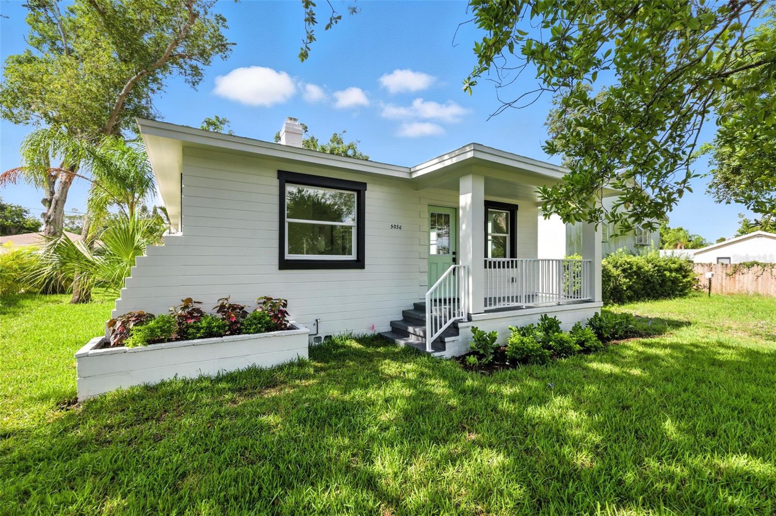 Welcome to 5036 22nd Ave N in the heart of St. Petersburg! This fully renovated block construction home features a complete 3-bedroom, 2-bathroom main residence plus a private detached efficiency unit in the rear—complete with its own full kitchen, walk-in shower, full bath, walk-in closet, and ample space for a king-size bed with a seating area. Perfect for multi-generational living, guest accommodations, or long-term rental income. The main home is filled with natural light and showcases a jaw-dropping kitchen with modern finishes, dining space, and inside laundry. No detail was overlooked—new roof, new windows, new A/C, new hot water heater, new flooring, updated plumbing and electrical, fresh landscaping, and a full irrigation system. Additional features include alley access, a non-flood zone location, and a neighborhood surrounded by new construction homes—all adding to the long-term value and appeal. This is a rare opportunity to own a move-in-ready, income-producing property in one of St. Pete’s most convenient and growing areas—close to shopping, dining, downtown, and the beaches. This home truly has it all.