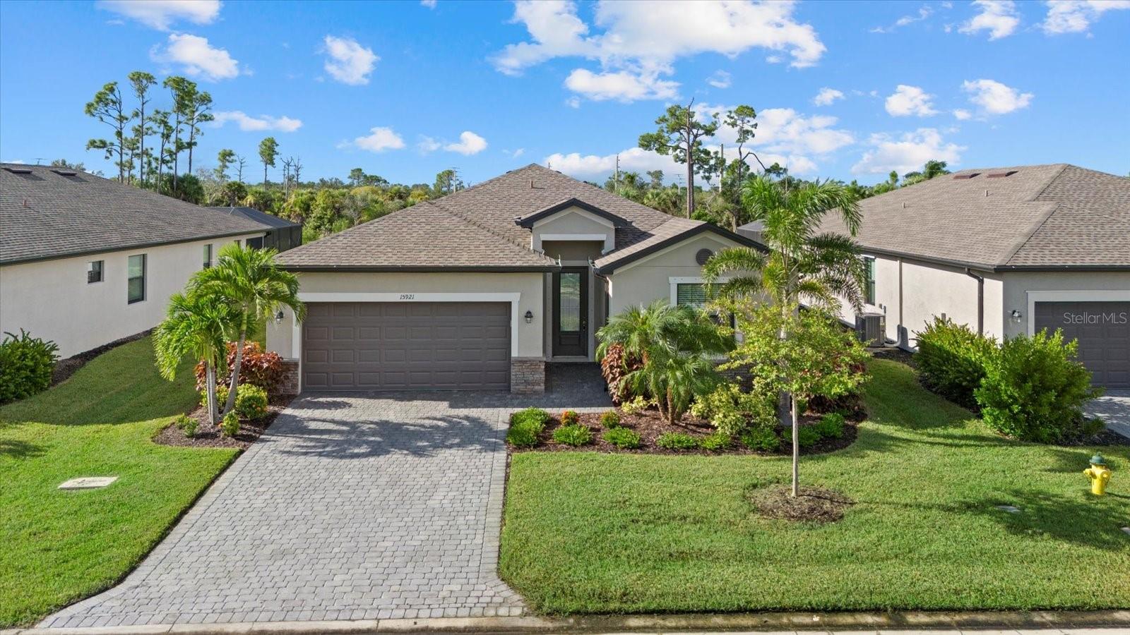 If you have been waiting for a newer, larger, 2,000+sq.ft., 4 bedroom, 3 bathroom home with a larger screened lanai with a private pool and spa, your wait is over. Upon arriving at this home on the paver driveway and landscaped entrance way, you enter the foyer of this light and bright home. Moving forward into the large living area, the open floor plan offers the spacious combination of the living, dining and kitchen. The area is neutral in color and has ceramic tile floors. The kitchen offers granite counter tops, stainless steel appliances, a large center island with breakfast bar and a corner pantry, all perfect for the chef in the family. Off the foyer to the right are two bedrooms with a bathroom in between and to the left is the fourth bedroom with ensuite bathroom. Both bathrooms have a single sink vanity with granite countertops and a tub/shower combination. The spacious primary bedroom offers two walk-in closets and an ensuite bathroom. The bath has a double sink vanity with granite countertop and is over 8 feet long, private commode room, linen closet and 4 feet by 9 feet walk-in tiled shower. The four bedrooms all are carpeted, have ceiling fans and nice closets. The home has an indoor laundry room with full size washer and dryer and enters out to the double car attached garage. From the living room by way of a triple slider, you enter out into the oasis of the home. The hugh lanai offers a covered space, 8 feet by 18 feet, for relaxing out of the sun. Then the screened portion of the lanai is 22 feet by 40 feet with a heated inground swimming pool, 12 by 23, and an attached spa, 7 by 7, that has cascading water flow into the pool. The total deck of the lanai is pavers for a beautiful effect with the coping edge of the pool and spa. The perfect combination for relaxing, reading a good book, enjoying your morning coffee or afternoon wine and cheese or just entertaining family and friends. The view from the lanai is the pond behind the home for privacy and watching nature. All of this located in the gated community of Biscayne Landing which has clubhouse with a fitness room, swimming pool with sundeck, tennis and pickleball courts. The HOA includes lawn care and basic cable and internet and no CDD Fees. The community is located close to shopping, restaurants, golf courses, local beaches and world class fishing, baseball spring training facilities and local attractions. You must see to totally appreciate this home.