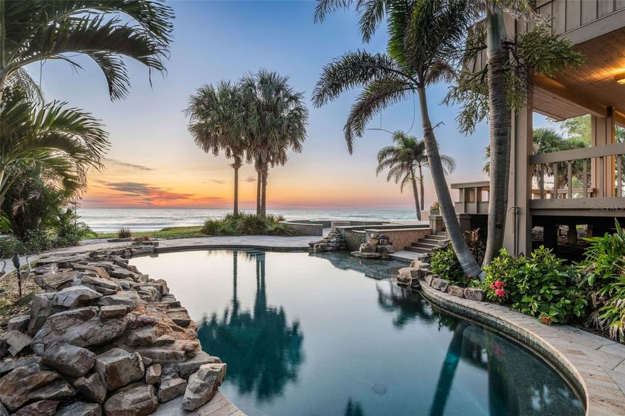 Nestled on OVER AN ACRE of breathtaking PRIVATE BEACHFRONT PROPERTY, this uniquely designed residence at 400 Gulf Blvd  is a masterpiece. With 160 FEET of pristine GULF VIEWS, this one-of-a-kind home features 5 bedrooms and 4 bathrooms, offering unparalleled vistas of the Gulf of Mexico. The living room, adorned with a two-sided beautiful stone fireplace, boasts vaulted ceilings, setting the stage for elegant gatherings. The kitchen's views will inspire any at-home chef.
The office becomes a genuine sanctuary, where the two-sided fireplace, bespoke library loft, and unmatched water views seamlessly converge to create a refined yet cozy ambiance. Two generously sized bedrooms on the lower level offer privacy, each leading out to a secluded porch area. Ascend to the upper floor to discover the magnificent master suite, complete with a private balcony, dual walk-in closets, an expansive walk-in shower, and a luxurious soaking tub that offers breathtaking views of the beach—a true haven. An additional two-bedroom suite on the second floor features a comfortable living area, a private balcony, and a full bath with two bedrooms.
Step outside onto the one-of-a-kind wrap-around deck, offering multiple levels for outdoor enjoyment. The stone-adorned pool area features multiple cascading waterfalls, an elevated connected spa, and a cozy fire pit, all framed by the stunning backdrop of the Gulf of Mexico. The property is complemented by an expansive brick paver driveway and lush landscaping, creating a truly unique coastal paradise. Situated in the highly coveted Belleair Shores, this residence provides the rare opportunity to own prime real estate. Don't miss this chance to own an extraordinary home in one of the most sought-after locations on the West Coast of Florida.