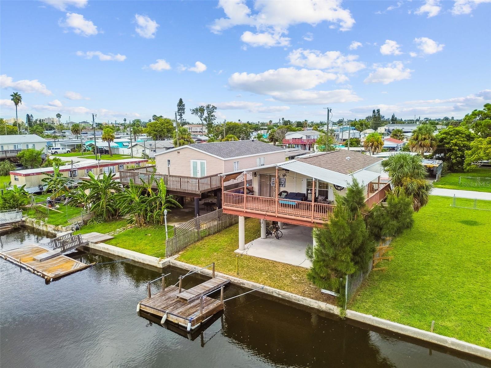 Dreaming of a waterfront lifestyle? This beautifully remodeled 2-bedroom, 2-bathroom stilt home sits on a deep-water canal with its own private boat dock and offers direct Gulf of Mexico access—just minutes to open waters. Located down the street from Hudson Beach with public boat docking, restaurants, and entertainment, this move-in-ready home features an open floor plan, updated finishes, and a wrap-around balcony on two sides—perfect for enjoying stunning sunsets. Major updates include a new roof, 2021 HVAC, and 2020 hot water heater. The fenced yard is ideal for pets, and the elevated design provides ample covered parking for vehicles, golf carts, or recreational toys. With no HOA or deed restrictions, this property is perfect as a full-time residence, vacation retreat, or investment opportunity.