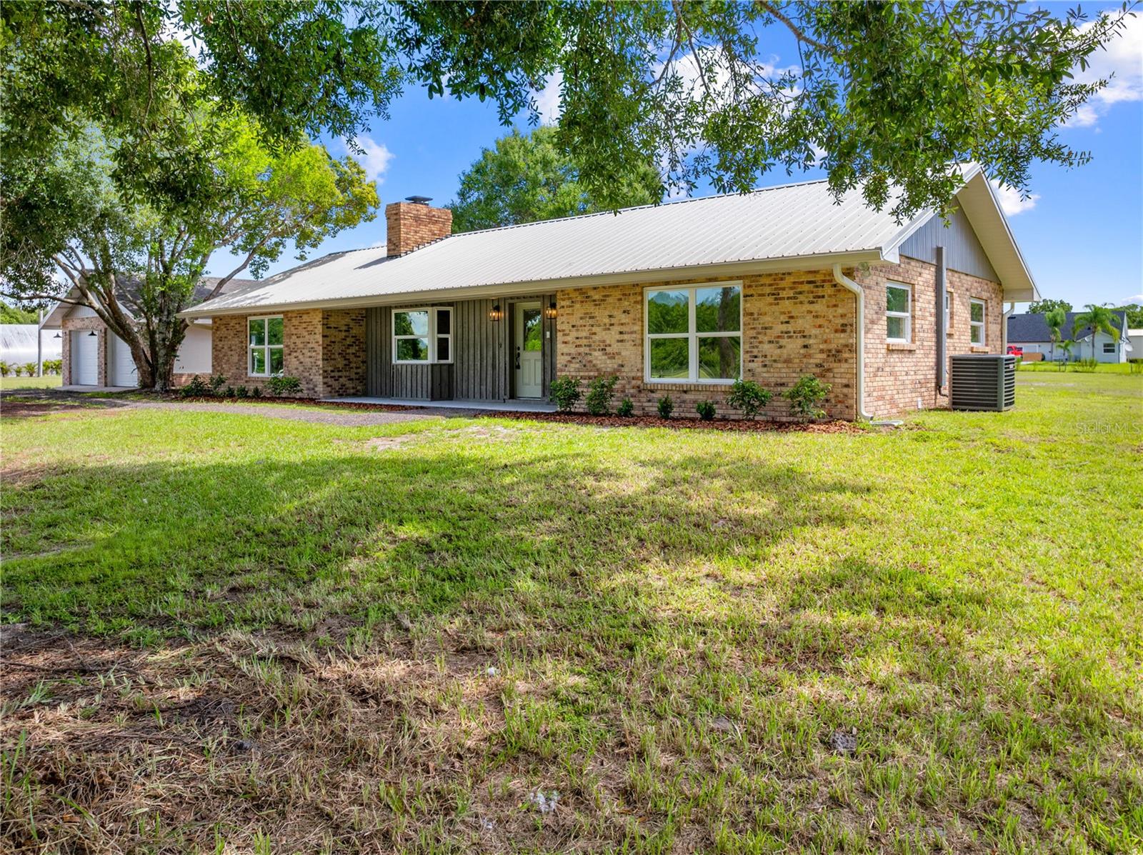 Check it Out! This Fully remodeled 3 bedroom, 2 bathroom home on just under 3 acres! High and dry, all usable land provides plenty of room for animals, toys, or future projects. Inside, the split floor plan offers privacy and functionality. The brand-new kitchen features quartz countertops, stainless steel appliances, and modern finishes. The guest bathroom has been fully updated with floor-to-ceiling tile, a new vanity, and fresh tops. The large master bedroom is filled with natural light from multiple windows and connects to a completely renovated master bath with a walk-in shower and glass enclosure. I Dont want to forget to mention a Brand New A/C System as well as New windows, plumbing and updated electrical and fixtures. Outside, you’ll find an oversized 2-car detached garage, perfect for vehicles, storage, or a workshop. All this with a prime location close to Orlando International Airport, the beaches, and Central Florida’s world-famous theme parks!