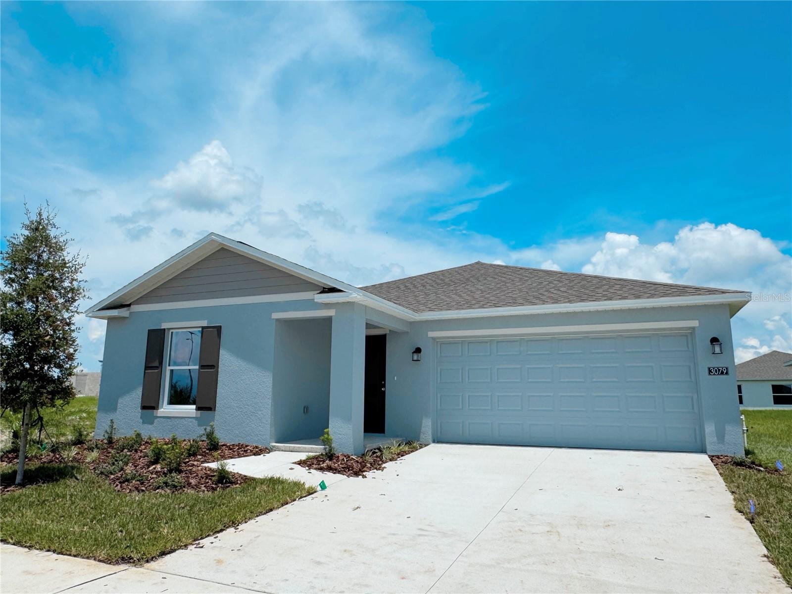 Welcome to your brand-new one-story home, featuring a 3-bedroom, 2-bathroom home that offers both style and comfort. Step inside and spoil yourself with the upscale Bloom floor plan, designed for effortless living and entertaining. The open-concept layout features a gorgeous kitchen with a center island, solid surface countertops, and brand-new stainless steel appliances, seamlessly flowing into a bright, airy family room. Host gatherings with ease or unwind in your private owner’s suite, complete with a serene bedroom, a spa-like bathroom, and a roomy walk-in closet. Two additional bedrooms and a sleek second bathroom provide ample space for family or guests. Everything is included – from the oversized tile flooring in wet areas to the low-maintenance finishes that blend style and practicality. Step outside to your huge backyard, a blank canvas for gardening, play, or future upgrades. The open floor plan is flooded with natural light and features a split-bedroom layout for added privacy, with 2 bedrooms in the front and a primary suite in the back. The modern kitchen comes with stainless steel appliances, a large island with a farmhouse sink, and plenty of cabinet and pantry storage. Enjoy the best of Florida living just 15 minutes from Winter Haven’s downtown, Legoland, and Winter Haven Hospital, with easy access to major highways. And this coming month, you’ll have access to incredible resort-style amenities including a clubhouse, swimming pools, cabanas, and a gym, and it is walking distance from this house. Don’t miss this beautiful home, schedule the showing now!