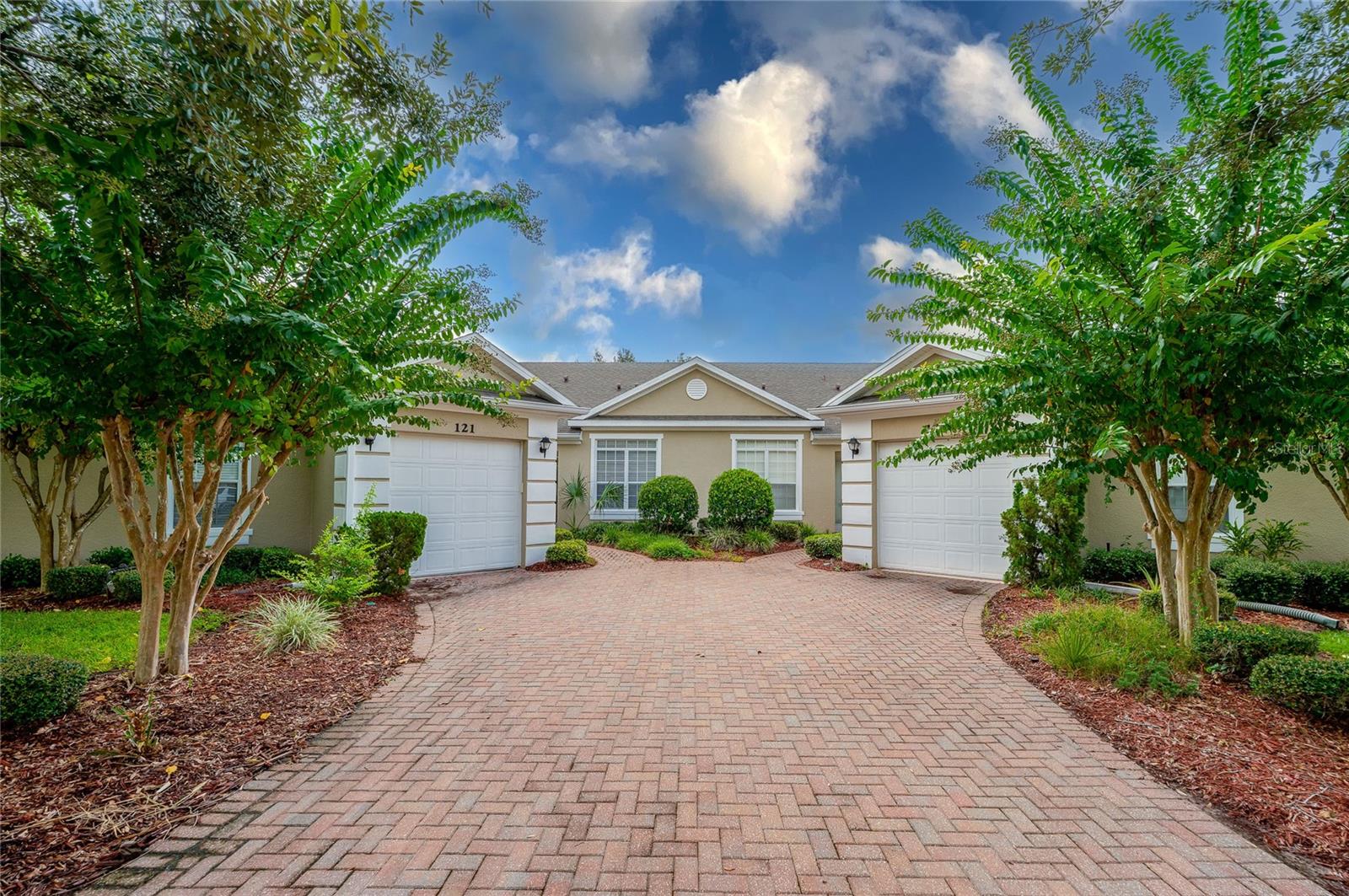 One or more photo(s) has been virtually staged. This beautifully maintained 2-bedroom, 2-bathroom single-level townhome at the coveted “Sedona” at LPGA golf community offers serene views and an inviting open-concept layout. From the charming paver driveway and tropical landscaping to the covered front entry, every detail adds to this home's curb appeal. Inside, the spacious kitchen features stainless steel appliances, ample cabinetry, a stylish tile backsplash, recessed lighting, and a convenient breakfast bar that connects seamlessly to the dining and living areas. Tray ceiling with ambient lighting, soft architectural arches, and large sliding glass doors enhance the expansive living room. Step outside to a peaceful screened lanai overlooking lush landscaping and mature shade trees offering lovely, wooded views and a relaxing outdoor retreat. The generous primary suite includes a walk-in closet, along with an ensuite bath boasting a double sink vanity, soaking tub, and separate glass-enclosed walk-in shower. A second bedroom offers comfort and privacy for guests, with easy access to a full guest bath. A dedicated laundry room with built-in shelving and an attached one-car garage add everyday functionality. Virtually maintenance free as HOA covers roof, exterior and grounds. Various memberships to world class golf and a community pool are available for an additional fee. Ideally located just minutes from I-95 and I-4, you’ll enjoy quick access to LPGA International Golf Course, Embry-Riddle Aeronautical University, Daytona International Speedway, One Daytona, Tanger Outlets, Daytona International Airport, and, of course, the iconic “World’s Most Famous Beach. All information recorded in the MLS is intended to be accurate but cannot be guaranteed.