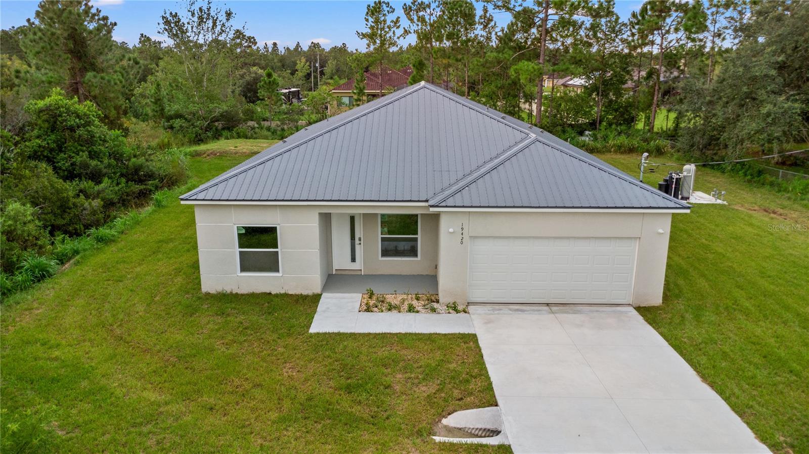 Welcome to this custom-built steel framed home, set on just over 1 acre in the desirable Wedgefield community. Surrounded by trees and natural greenery, this private retreat offers a peaceful lifestyle while still being just 25 minutes from downtown Orlando, 18 minutes from the airport, and 35 minutes from the beaches.
This spacious 5-bedroom, 3-bathroom home features an open split floor plan with soaring 9’ ceilings and vinyl flooring throughout. The kitchen is the heart of the home, complete with custom European-style cabinetry, stainless steel appliances, a large island with quartz countertops, seating, and a stunning waterfall edge design.
The master suite offers dual walk-in closets, a spa-like bathroom with a freestanding tub, separate shower, and dual sinks. A private mini suite with its own entrance provides the perfect setup for in-law quarters or guests.
Additional highlights include a zoned mini split A/C system, deep well with water treatment system, covered front entry, and a 2-car garage. With plenty of space for animals or simply enjoying nature.
Don’t miss the chance to own a unique home offering both privacy and convenience—schedule your showing today!