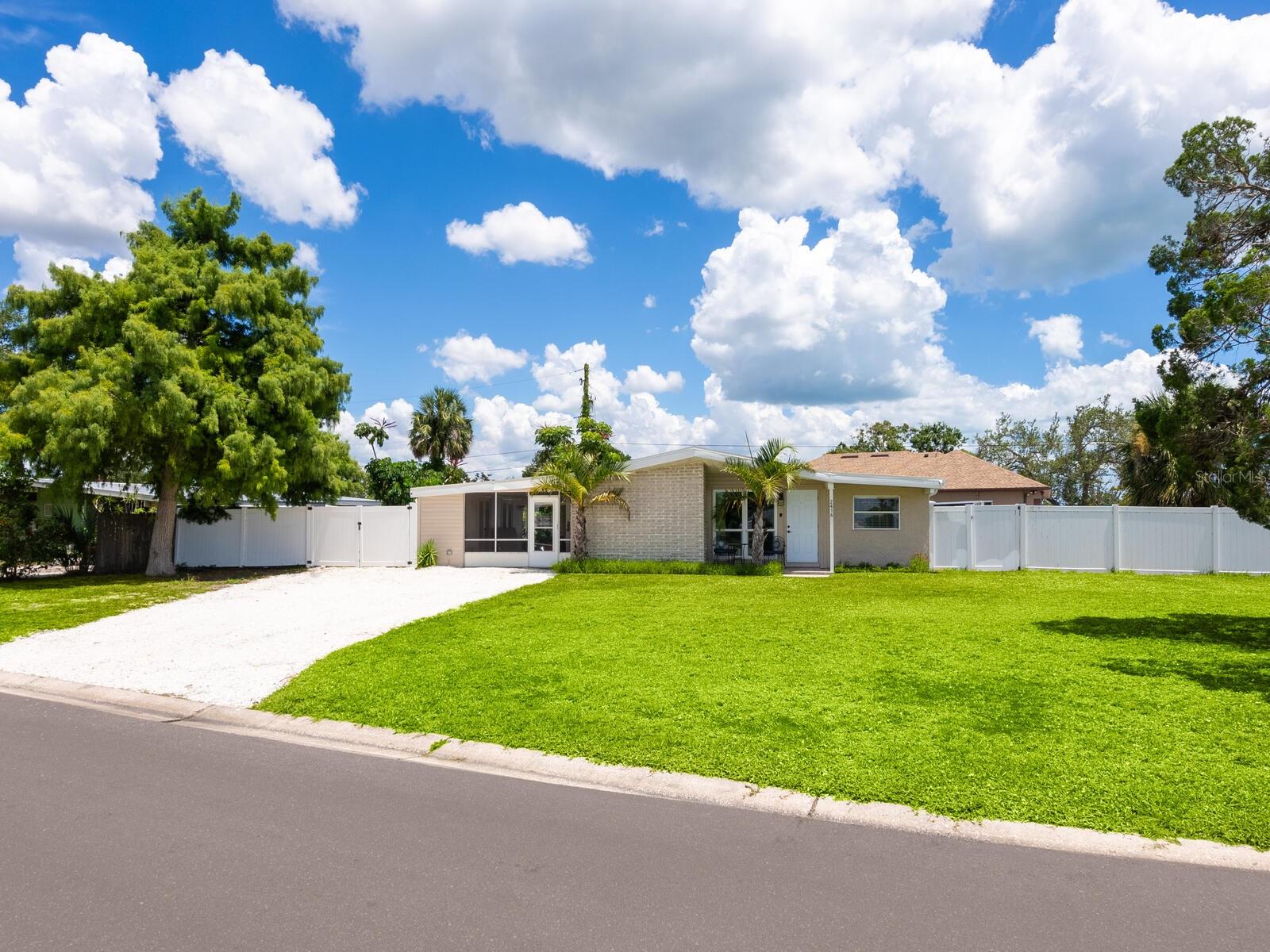 This Beautifully updated 3-bedroom, 1.5-bath saltwater POOL home blends modern aesthetics with classic Bayshore Gardens character and is located on a corner lot. Originally built in 1958, the home has been fully renovated from floor to ceiling while maintaining its solid construction and charm. The sellers have recently installed new windows, freshly painted and prepared the home to be move in ready for the new home owners. Enjoy outdoor living with a covered seating area, outdoor shower, fenced yard, and newly landscaped grounds. Double-gate access makes it easy to park a boat or RV, and there's ample additional parking on a wide shell driveway. The home also features epoxy flooring throughout, hurricane shutters, and multiple outdoor storage areas. An extra bonus room at the back of the home, with its own private entrance, is currently used for storage but offers great potential. It could be converted into a home office, guest suite, or expanded into a full bath and walk-in closet to create a private en suite for the primary bedroom. Bayshore Gardens Residents have access to a wide range of amenities including a Jr. Olympic-size swimming pool, clubhouse, playground, basketball courts, baseball field, pickleball courts, marina, private boat ramp, fishing pier and grilling/picnic area. With no HOA or CDD fees and no requirement for flood insurance, this property is a smart investment. Come see it today
