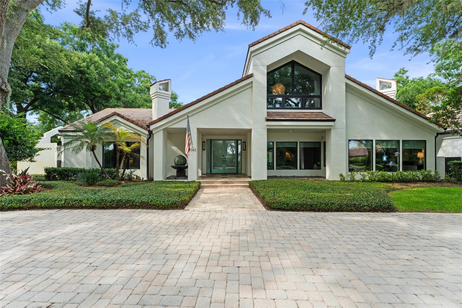 Nestled at the end of a quiet cul-de-sac on 1.15 acres within the renowned Isleworth Golf & Country Club, this exceptional residence offers refined luxury, thoughtful design, and exceptional grounds designed for outdoor enjoyment all year round. Featuring five bedrooms, six full bathrooms, and a powder room, the home spans more than 6,300 square feet, with lovely architectural style and beautifully appointed interiors. The stunning great room is a true centerpiece, featuring soaring cathedral ceilings, exposed wood beams, and abundant natural light. Formal living and dining rooms provide ideal spaces for entertaining, while the chef’s kitchen boasts granite countertops, white cabinetry, and high-end Bosch and Sub-Zero appliances. The primary suite is a serene retreat, featuring a luxurious en-suite bath and direct access to the pergola and pool for seamless indoor-outdoor living. Upstairs, a versatile bonus room offers flexible space for a yoga studio, home gym, game room or creative retreat, complemented by a stylish loft office perfect for work-from-home needs. Step outside to discover the expansive backyard complete with modern pool is surrounded by low-maintenance artificial turf, expansive lanai spaces for alfresco dining, and multiple seating areas ideal for gatherings or quiet relaxation—all framed by a vast, fenced yard. This extraordinary home offers both comfort and sophistication in a community renowned for its golf, amenities, and lifestyle. A rare opportunity to live luxuriously in a premier setting.