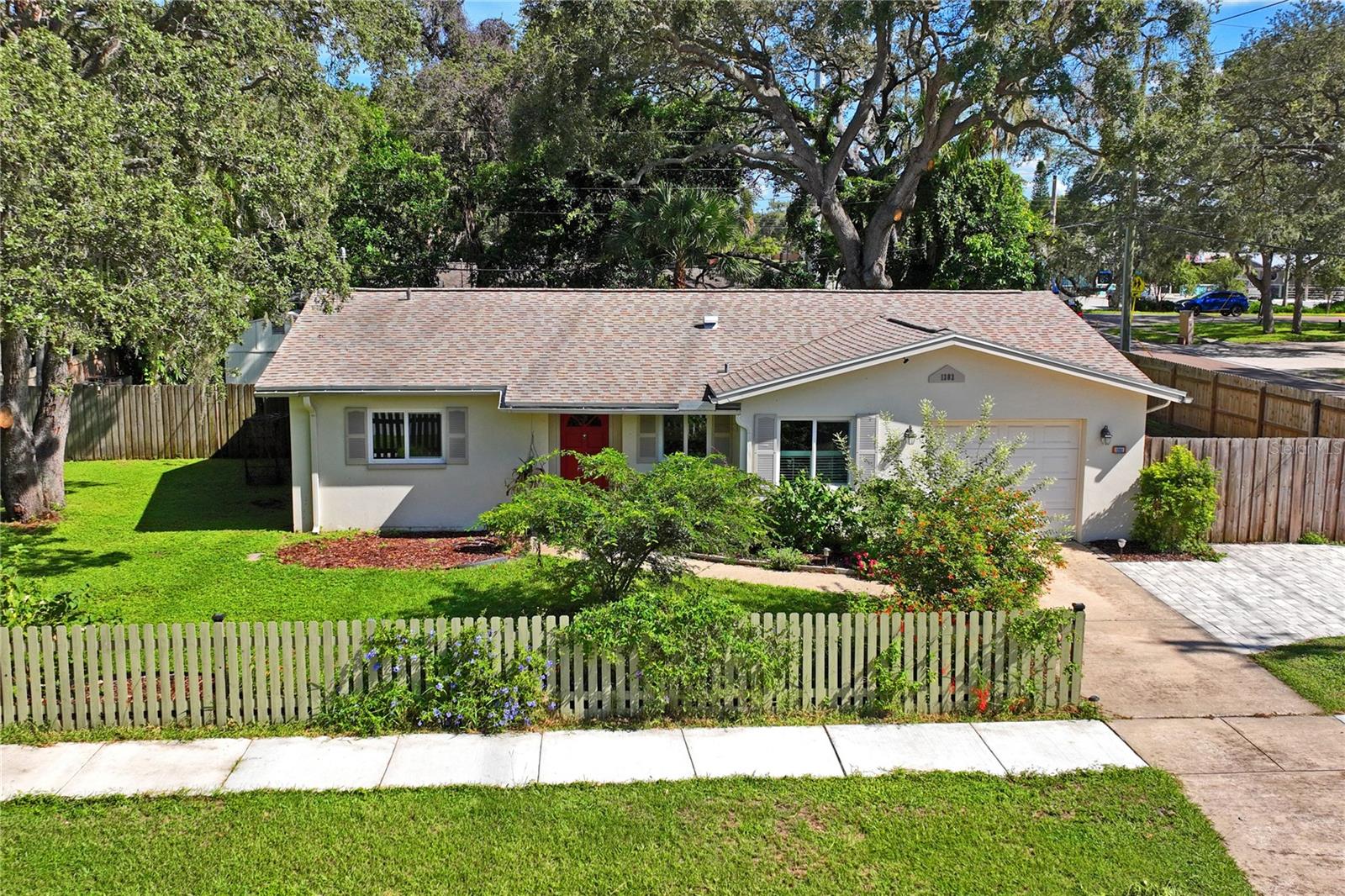 This updated home offers a blend of modern convenience and classic charm, making it an ideal rental. It features a newer electrical panel for peace of mind, a new roof, new A/C and ductwork, and new impact windows in the kitchen and bedrooms. The light and bright kitchen opens to a breakfast area overlooking a lovely front garden. The living room is a welcoming space, boasting new tile flooring and newly built-in shelving. The master bedroom, with its own full private bathroom and French doors, provides a versatile space. Sliding glass doors lead from this bedroom to a gorgeous screened-in back patio and an additional open patio. The second and third bedrooms feature Terrazzo flooring and spacious closets. Outside, you'll find a private, fenced-in backyard oasis complete with a newly built gazebo, perfect for entertaining. The large, treed lot includes side yards with ample space for your boat and RV. A large shed offers plenty of storage. Lawn care and exterior pest control included in monthly rent!