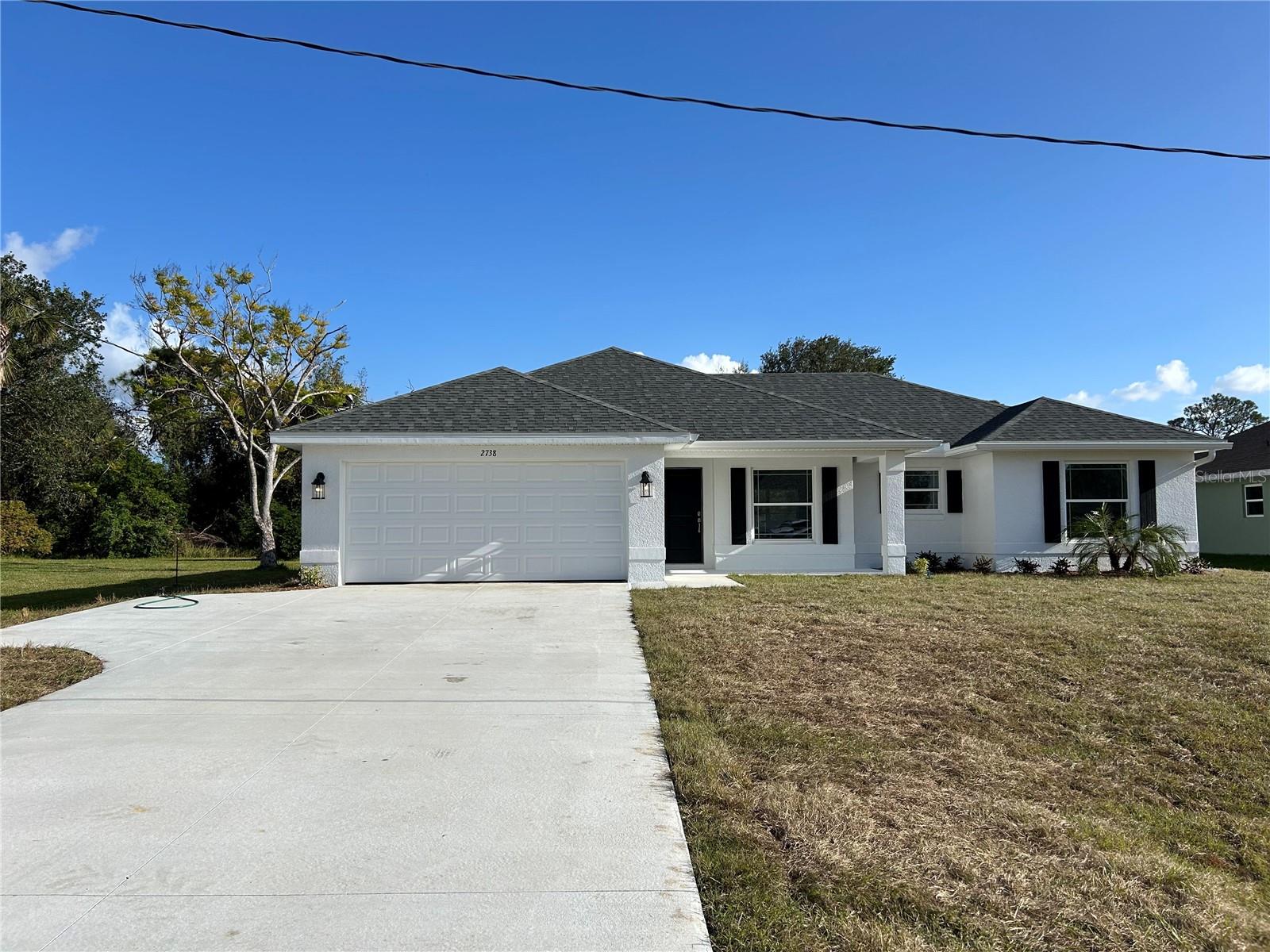 Under Construction. MOVE IN READY!! Welcome to your new home in beautiful North Port, Florida! This charming 3-bedroom, 2-bathroom residence with a 2-car garage offers a perfect blend of comfort and style, situated in such a vibrant community. This house is on City Water.
Designed for privacy and convenience, this split floor plan is perfect for families and guests. The spacious living room, with its vaulted ceilings, enhances the open, airy feel of the home. Ceramic tile flooring runs throughout, with plush carpet in the bedrooms providing a cozy touch.
The Owner's Suite is a highlight, featuring double vanities, a walk-in closet, and an upgraded, 5 foot, fully tiled shower. The kitchen is well-equipped with stainless steel appliances, including a range, microwave, and dishwasher. Quality fixtures such as brushed nickel Moen faucets, LED lighting, and 5-panel doors add a touch of elegance to the home. Efficiency is a key feature, with double pane tilt-in windows ensuring easy cleaning and lower utility costs. Additional features include 5 1/4" baseboards, upgraded painted cabinets, and a built-in pest defense system.
The exterior of the home boasts a professional landscaping package, adding curb appeal and ease of maintenance. The property is on city water, providing reliable and convenient service. The builder offers a comprehensive warranty package, including a 1 Year Workmanship, 2 Year Systems, and 10 Year Structural Warranty for peace of mind. Most closing costs are covered with an approved lender, making your move even easier. You can secure this home with only a $1,000 deposit, and the pricing includes the lot.
North Port is a thriving community with a wide array of attractions and amenities. Enjoy outdoor recreation in nearby parks, golf courses, and the Warm Mineral Springs. There is convenient access to local shops, restaurants, and cafes, and some of Florida’s best Gulf Coast beaches are just a short drive away. This family-friendly area boasts excellent schools, community centers, and numerous activities for all ages. Additionally, you’ll be close to top-notch medical facilities and services.
Don’t miss the chance to own this incredible home in one of Florida’s most desirable, growing communities. Schedule a viewing today and make this North Port gem your own!