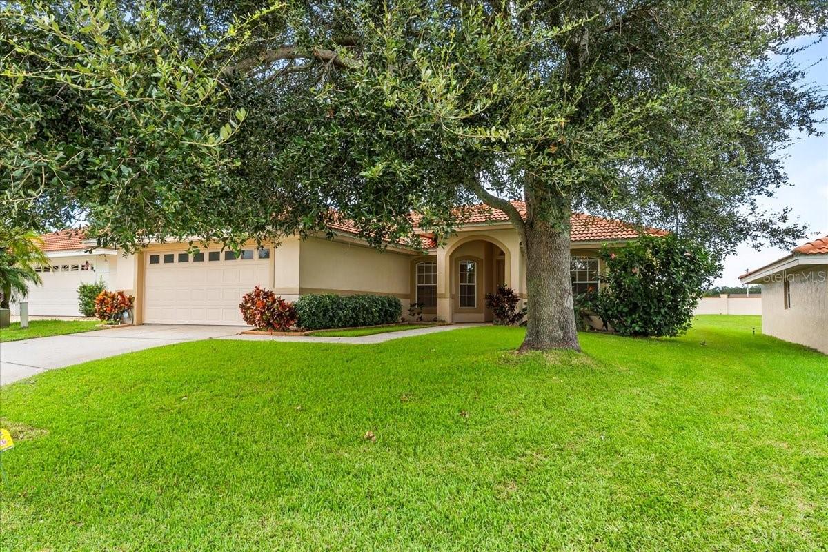 Located in the gated and guarded community of Winterset in SE Winter Haven, this beautifully maintained 3-bedroom, 2-bath home offers a spacious and functional layout with great indoor and outdoor living. The open floor plan features a split-bedroom design, elevated ceiling heights, and a large great room that flows seamlessly into the dining area and Florida room. The kitchen is well-appointed with a full appliance package, closet pantry, breakfast bar, and a charming dinette, along with an inside laundry closet complete with washer and dryer. The primary suite is generously sized with a large walk-in closet and an ensuite bath featuring dual sinks and a walk-in shower. The guest bedrooms are equally spacious, and the third bedroom stands out with its custom shiplap accent wall. Conveniently located near the secondary bathroom with a tub, the guest wing also includes two linen closets for added storage. The Florida room offers flexible use as an office, den, craft space, or playroom. Step outside to enjoy the large yard with a mature oak tree, an irrigation system, an invisible fence for pets, and a backyard paver patio with a fire pit—perfect for entertaining under the stars. The home also features a tile roof and a 2-car garage. Situated within Winterset, a desirable lakefront community on Lake Winterset, residents enjoy access to a clubhouse, pool, spa, shuffleboard and tennis courts. Conveniently located near Legoland Florida, Publix, Walmart, restaurants, and the new AdventHealth ER, with easy access to Tampa, Orlando, and Florida’s stunning beaches. Embrace the Florida lifestyle in this sought-after community where comfort, convenience, and security come together.