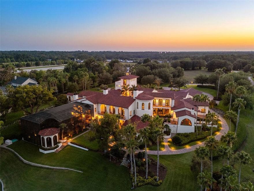 Presenting a truly rare and exceptional opportunity: a distinguished lakefront estate coupled with an adjoining commercial parcel —perfectly suited for an expansive residential compound, corporate retreat, boutique hotel, or world-class wedding destination, where the possibilities are as expansive as the grounds themselves. Positioned on 22 gated acres and 682 feet of waterfrontage along Lake Thonotosassa, this residence boasts over 25,000 square feet of inspired architecture, redefining the concept of a private estate. Welcome to an iconic estate, where timeless elegance meets the serene beauty of nature. From the moment you arrive, you’ll sense the majesty of the property, the unparalleled craftsmanship, thoughtful design and breathtaking views that define this extraordinary residence. A grand entrance sets a stately tone, opening to elegant living areas and thoughtfully designed courtyards that offer tranquility and seclusion. A cheerful portico welcomes guests with colorful, professionally landscaped gardens, creating a warm and inviting first impression with vibrant seasonal blooms. Designed as a living work of art, the home features extraordinary architectural fidelity and intentional design at every turn. An immersive experience in American heritage and cultural elegance, the home includes a meticulously recreated Oval Office and a scaled replica of the famous Tampa Theatre, offering a cinematic environment rich in detail. A dedicated memorabilia room serves as a gallery of curated history. Craftsmanship with intention is evident throughout, with extensive custom millwork, precision moldings, elevated ceilings and artisanal finishes adorning every space. The estate comprises 6 luxurious suites, 12 opulent baths, and over 34,000 total square feet of inspired architecture and functionality. Unique additional rooms, terraces, galleries and conveniences are located strategically throughout. The scenic North Tower suite has a dedicated entrance and parking. Resort-style amenities offer a lagoon-inspired, tiered-level pool complete with cascading waterfall and a zero-entry edge, expansive outdoor entertaining areas and serene lake views, creating an ideal sanctuary for luxury living. This magnificent estate is suited for a discerning collector, history enthusiast or visionary seeking an enduring architectural legacy in the Tampa Bay region. But this listing is just half the story… The adjacent waterfront parcel with the commercial venue is being offered creating a once-in-a-generation opportunity to own both a luxury residence and fully operational event business. Together, the properties span 22 gated acres, making this the ultimate turnkey private residential compound or boutique hotel development, an elite corporate retreat center or a global wedding destination. Born from a dream and nurtured with love, Mision Lago is an immersive experience steeped in charm, purpose, and potential. The moment you pass through the gates, you feel the care and passion woven into every structure, every garden, every detail.