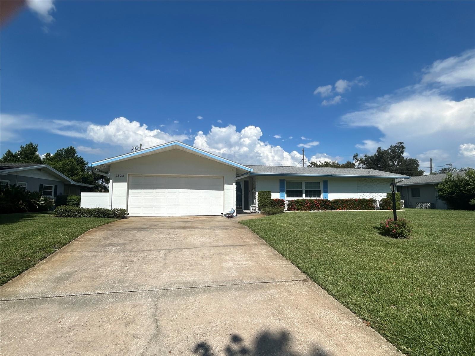 Welcome to this spacious and well-maintained 4-bedroom, 2-bathroom home with a 2-car garage, ideally situated in one of the area's most sought-after neighborhoods. Conveniently located within walking distance to the elementary, middle, and high schools, this property offers exceptional accessibility for families and professionals alike. Inside, you'll find a versatile floor plan ready for your personal touch. The home features a large screened lanai perfect for entertaining, a fully irrigated yard with mature landscaping, and a private backyard oasis. Additional highlights include hurricane shutters for added peace of mind, a roof that is only 8 years old, and a newer AC unit installed just 5 years ago. Whether you're looking for a primary residence or an investment opportunity, this property holds incredible potential in a highly desirable location.