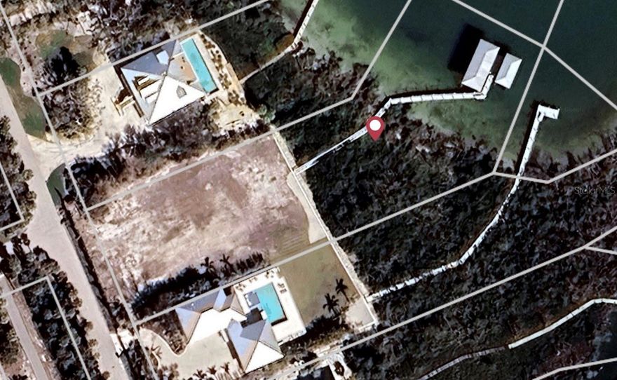 Great location with a deep water, very well, protected dock on over an acre of land... directly across from the Boca Grande Club. You can build your Waterfront Dream Home