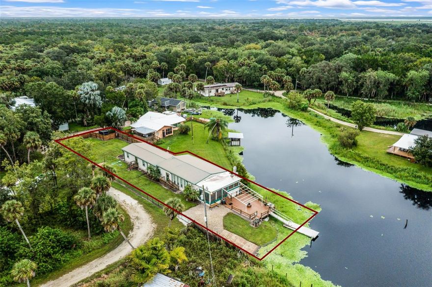 Welcome to this one-of-a-kind sportsman’s paradise in Mims, offering the perfect blend of comfort, recreation, and waterfront living. This 3 bedroom, 2 bathroom home sits on 0.44 acres across two parcels and offers direct canal access to the St. Johns River with a private dock and boat ramp right on the property, making it a dream for boaters, hunters, and fishermen alike. The outdoor living spaces are truly unmatched, with a large covered porch complete with a sink, built-in grill, mini fridges and freezers, kegerator and propane firepit. A spacious backyard deck provides an additional firepit, sink and fish-cleaning station, and plenty of room to relax or entertain after a day on the water. Inside, the home offers both a living room and family room/den, along with an indoor bar equipped with a mini fridge and kegerator. The kitchen boasts granite countertops, stainless steel appliances including refrigerator, oven, dishwasher, microwave, wine cooler, and food warmer, making it perfect for hosting gatherings or enjoying quiet evenings at home. The primary suite includes a versatile bonus space, and ceiling-mounted speakers run throughout the home for a true entertainment experience. Additional features include two approximately 250-gallon holding tanks with an alternate well available, a newer septic system, and two newer AC units. Although located in Flood Zone AE, this elevated home has never experienced water intrusion, even during major storms like Hurricane Ian. With no HOA, a quiet setting, and close proximity to Hatbill Park, Loughman Lakeside Restaurant & Bar, I-95, the Indian River, and the beaches, this property offers a rare opportunity for a full-time residence, weekend retreat, or sportsman’s paradise. Don’t miss your chance to own this ultimate getaway—schedule your private showing today!