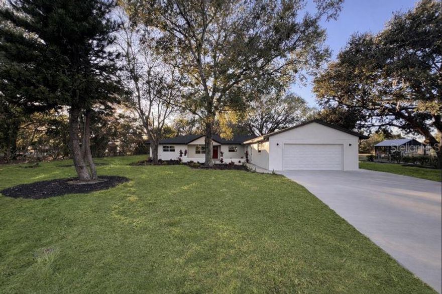Welcome to this stunning, fully renovated 4-bedroom, 3-bathroom residence located in the highly desirable Johns Lake Acres area of Clermont, Florida—where space, flexibility, and modern design come together on nearly a full acre with no HOA. This thoughtfully reimagined home offers exceptional versatility, including a private in-law suite complete with its own kitchen, full bathroom, and separate entrance—ideal for multigenerational living, extended guests, or income-producing potential. The main living area features an oversized great room designed for both everyday comfort and effortless entertaining. New porcelain tile flooring flows throughout the home, complemented by contemporary light fixtures, sleek modern finishes, and upgraded modern plumbing fixtures that elevate the overall aesthetic. The brand-new 2025 kitchen is a true showpiece, showcasing quartz countertops, stainless steel appliances, and a clean, modern layout perfect for hosting and daily living. All bathrooms have been completely remodeled in 2025 with stylish, spa-inspired finishes. Major system upgrades provide peace of mind, including a new roof (2025) and new AC (2025). Outdoors, the expansive 0.95-acre oversized lot offers privacy and endless possibilities. Enjoy Florida living at its finest with a spacious pool deck and spa—perfect for relaxing or entertaining—along with a large backyard that provides ample room for recreation, future additions, or custom outdoor enhancements. Nestled within a quiet, established section of Johns Lake Acres, this property delivers a serene residential setting while remaining conveniently close to SR 50, shopping, dining, schools, and Clermont’s scenic lakes. Offering modern upgrades, generous land, and no HOA restrictions, this move-in-ready home is a rare opportunity you won’t want to miss. PROFESSIONAL PICTURES COMING SOON.