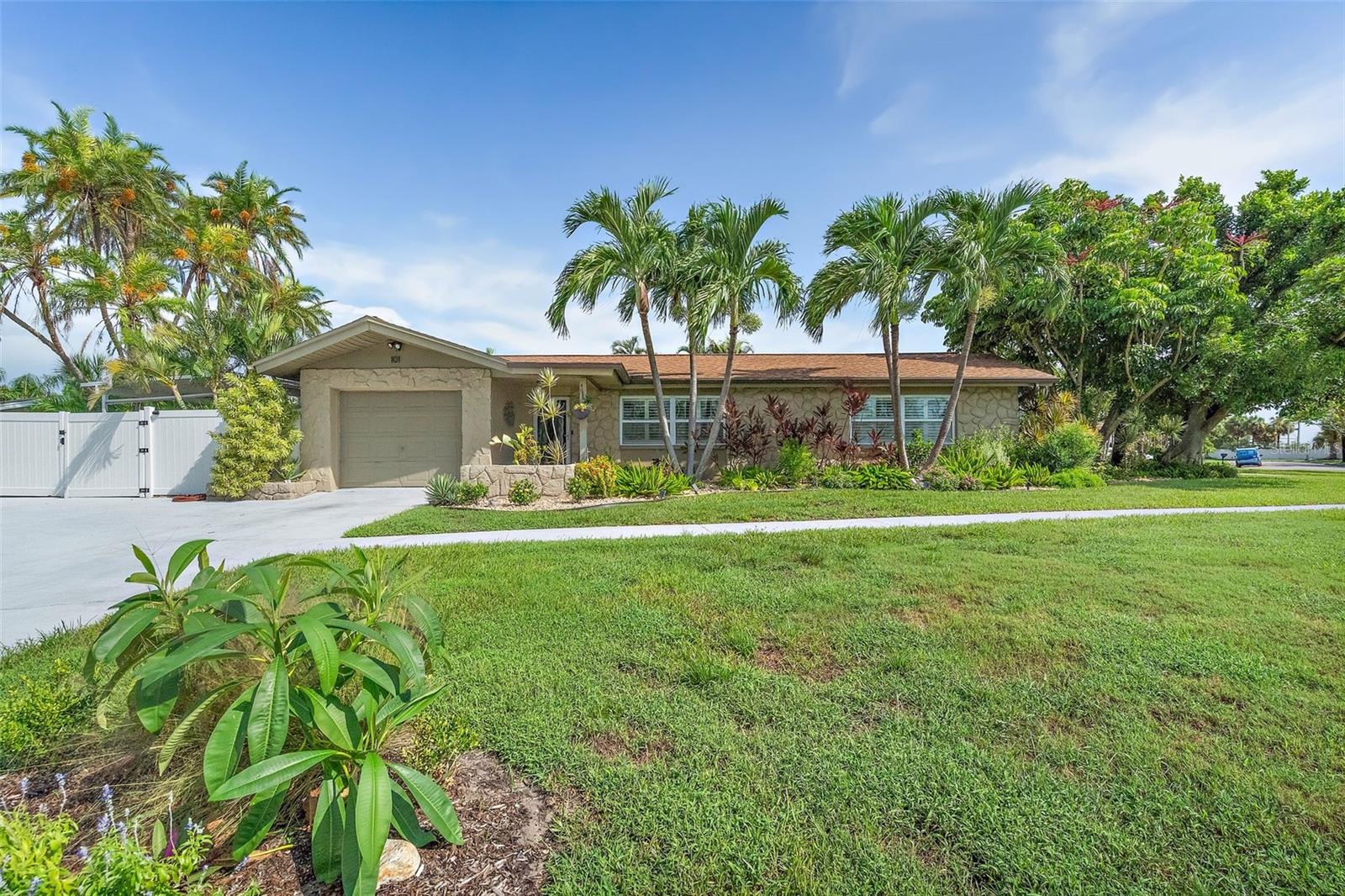 Fabulous Pool Home nestled in the heart of the coveted Tierra Verde community, this stunning home offers the perfect blend of modern updates and tropical charm. Located at the southern tip of St. Petersburg, Florida, Tierra Verde is renowned for its laid-back boating and fishing lifestyle, with direct access to nature and the beautiful Fort De Soto Park. Step inside to discover a fully updated kitchen featuring solid surface countertops, custom cabinetry, stainless steel appliances, a vent hood, and recessed lighting, all enhanced by high-quality fixtures. Both bathrooms have been elegantly updated with custom vanities, granite countertops, tile shower enclosures, and stylish fixtures and lighting. The home boasts diagonal tile throughout, creating a seamless flow from room to room. The spacious laundry room is equipped with built-in cabinetry for added convenience and storage. Outside, you'll find your own private tropical oasis. The lagoon-style pool is surrounded by lush landscaping, offering complete privacy, while the expansive lanai and pergola provide the perfect setting for outdoor dining or relaxing. There’s also an additional parking pad ideal for boat or RV storage. With its prime location, you'll have easy access to all Tierra Verde has to offer. The pristine Gulf beaches are just a short bike ride away, and you're only moments from some of the area's best fishing and nature spots. Plus, this home has not been affected by flooding, offering peace of mind for years to come. Whether you're looking for a seasonal retreat or a permanent residence, this home offers the ideal balance of luxury, comfort, and convenience. Pride of ownership is evident throughout – it’s a must-see!
